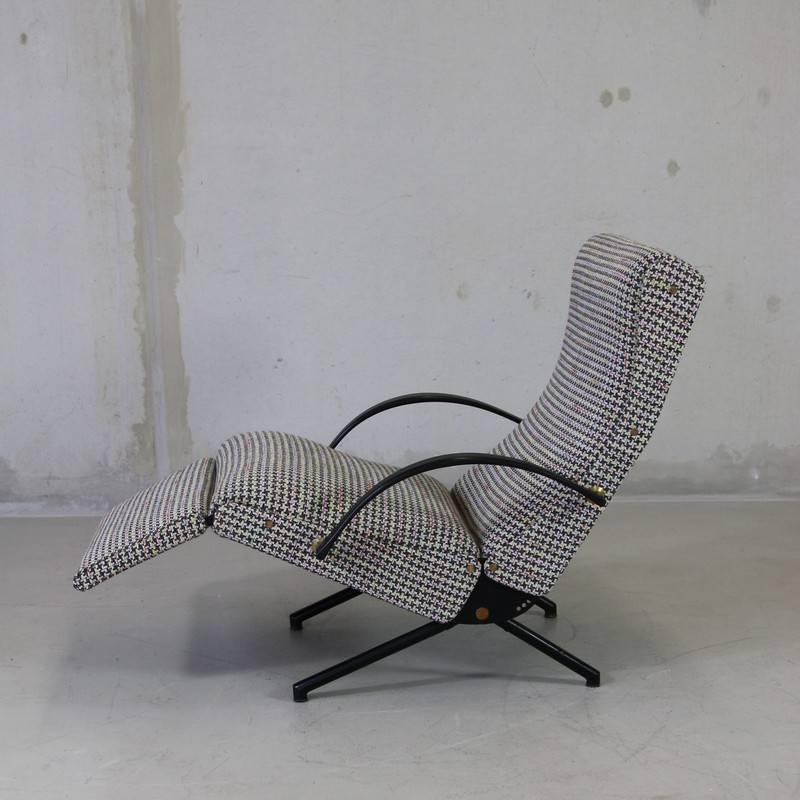 Reclining armchair designed by Osvaldo Borsani, Italy, 1955.

The 'P40' variable tilt armchair, produced by Tecno, Milan starting 1956. Black tubular frame with rubber armrests. Seat, back and foot rest upholstered in houndstooth fabric. The foot