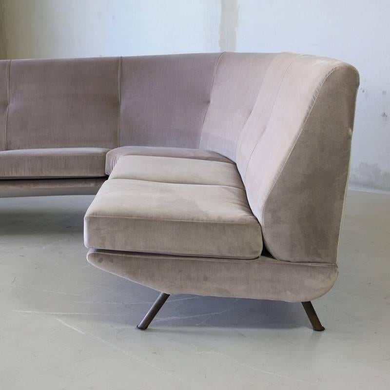 Large corner four/ five seat sofa, designed by Marco Zanuso. Italy, Arflex 1951.

Upholstered in a light grey/ purple velour upholstery, brass covered legs.

Reference for the Chair: Reference: Gramigna, G. Repertorio del design italiano, p 25