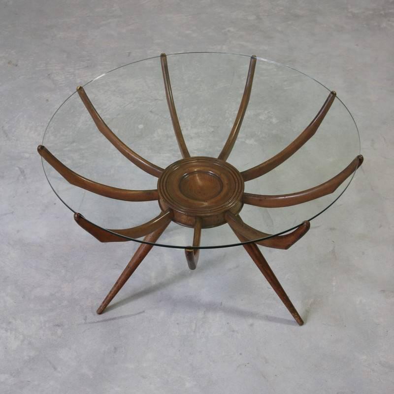 Coffee table attributed to Carlo di Carli, Italy, 1950s.

Wooden construction with round glass top insert.