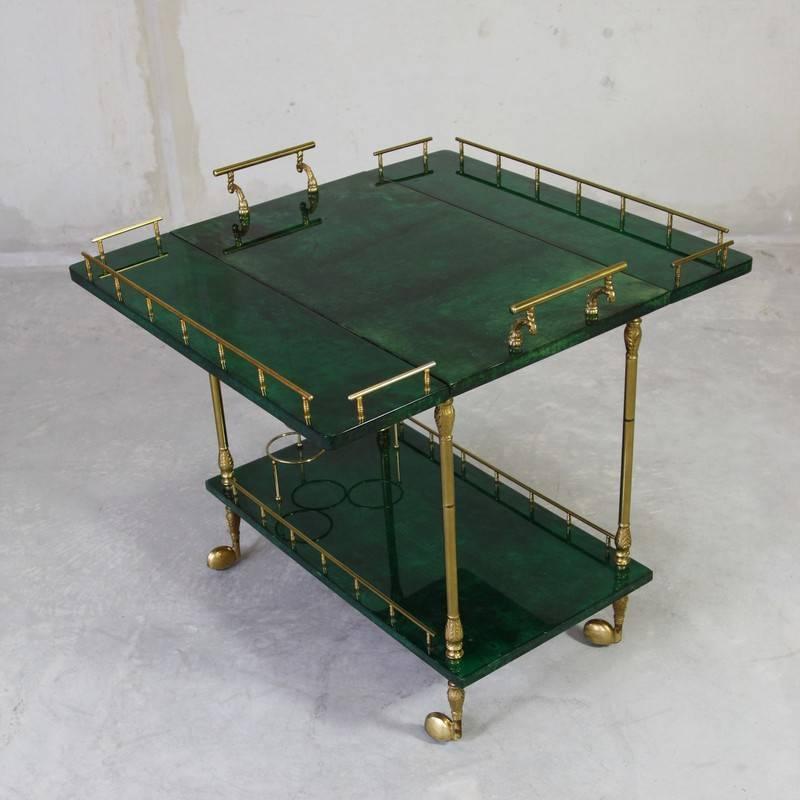 Two-tier trolley, designed by Aldo Tura, Italy, 1960s.

Trolley with folding sides, covered in coloured parchment and brass detail. The size of the top tray extends to 80 cm x 75 cm.