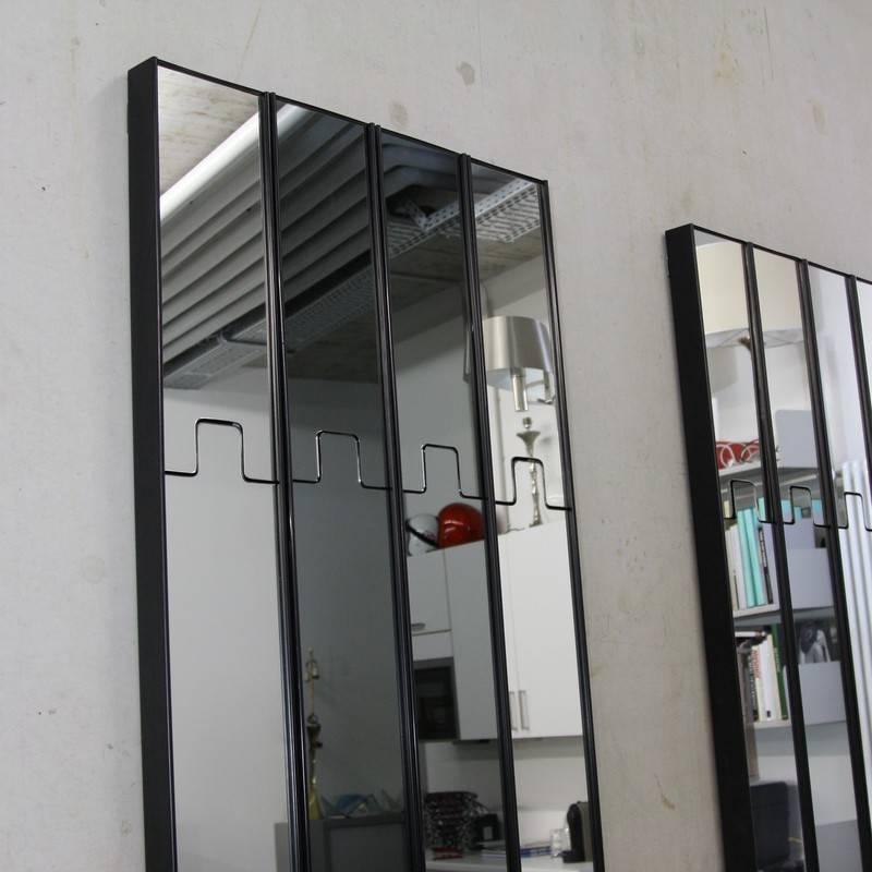 A collection of single mirror units, designed by Luciano Bertoncini, Italy, 1971.

A modular mirror unit Elco, including a spring mechanism, which can hold cloths, when pushed inside. There are different mirrors available including smoked, green