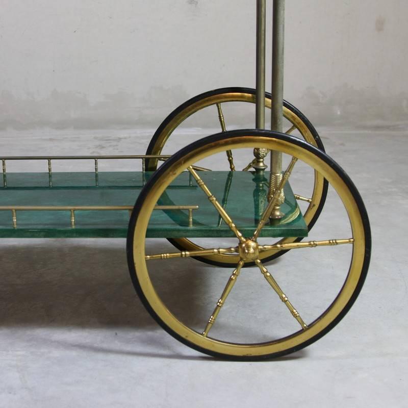 Two-tier trolley, designed by Aldo Tura, Italy 1960s.

Trolley with folding sides, covered in colored parchment and brass detail. The size of the top tray extends to 74 cm x 75 cm.
Condition: 

Excellent vintage condition, marked on the top