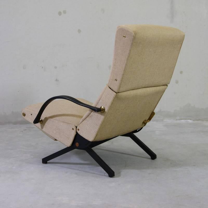 The 'P40' variable tilt armchair, produced by Tecno, Milan starting 1956. Black tubular frame with rubber arm rests. Seat, back and footrest upholstered in vintage wool fabric. The footrest is stored under the seat. Brass detail.

Second edition