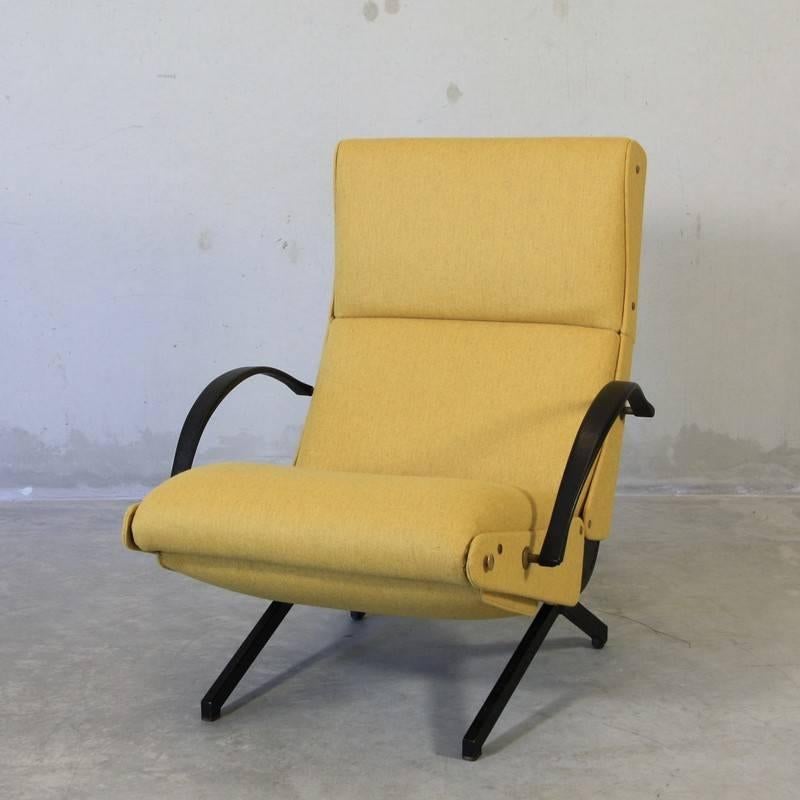 The 'P40' variable tilt armchair, produced by Tecno, Milan 1956. Black tubular frame with rubber armrests. Seat, back and footrest upholstered in yellow wool fabric. The footrest is stored under the seat. Brass detail.

Second edition of the