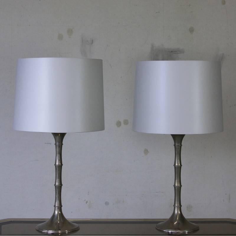 Pair of table lamps, designed by Ingo Maurer, Germany, 1970s.

Vintage chromed metal lamp bases with light silver blue silk lampshades.