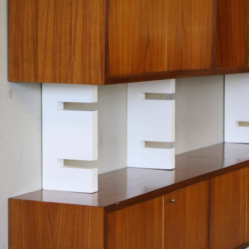 Shelving Unit with wooden cupboards in Mahogany veneer, AMMA, Italy, 1960s.

Rare shelving system, including a cupboard frontage with silkscreened door panel. The inside of all cupboards are lined in a light wood veneer, with glass or wooden