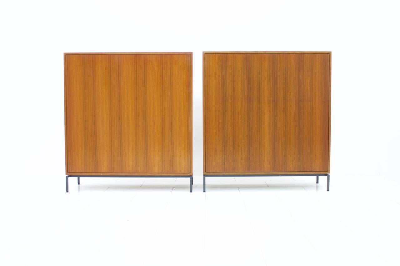 Pair of Herbert Hirche teakwood cabinets, high boards with metal base,
Germany, 1960s.
Very good condition.

Worldwide shipping.