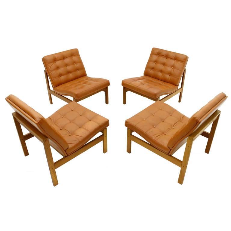 Set of four lounge chairs by France & Son. 
Teak and leather by Torben Lind and Ole Gjerlov for France & Sons Denmark, 1962. Good original condition.

Worldwide shipping.