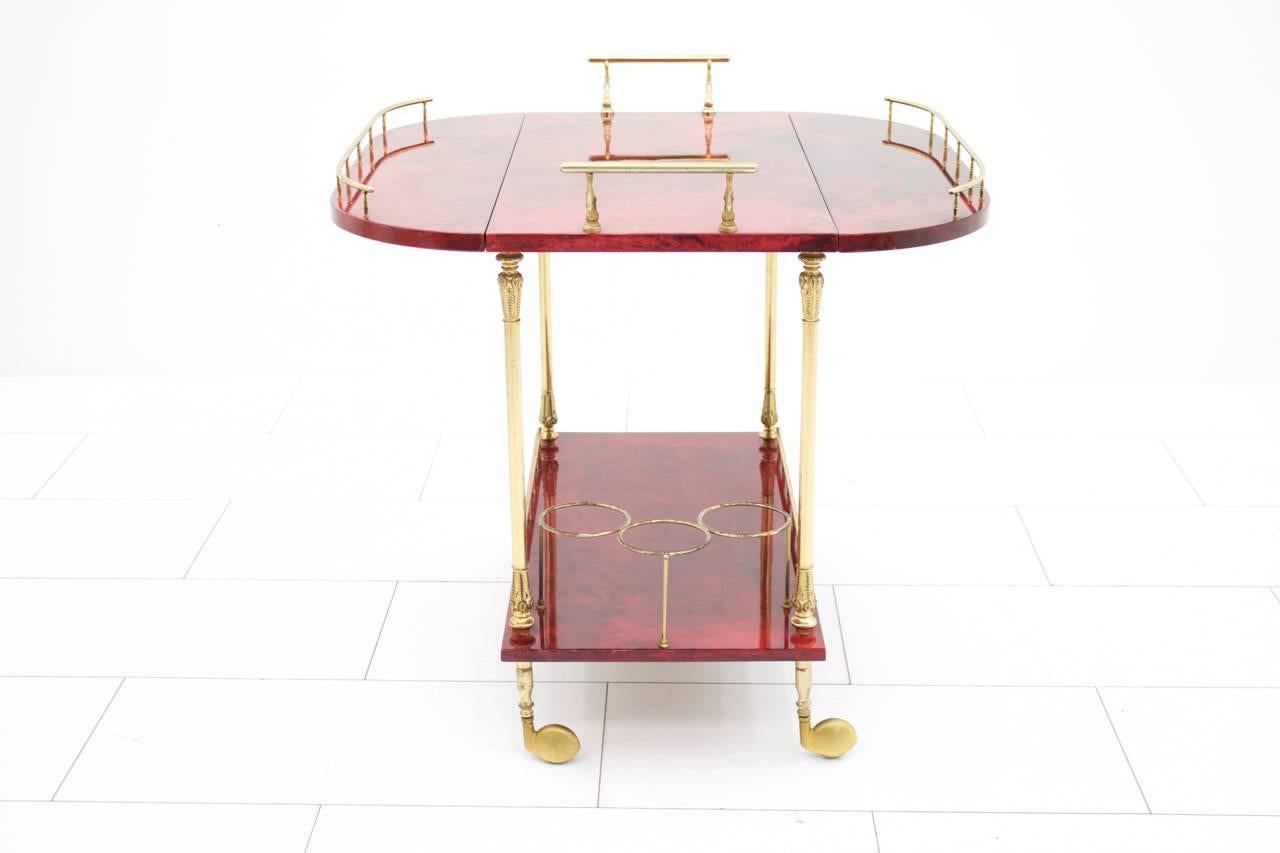 Large bar cart by Aldo Tura in red goatskin and brass.

Very good condition.


Worldwide shipping.