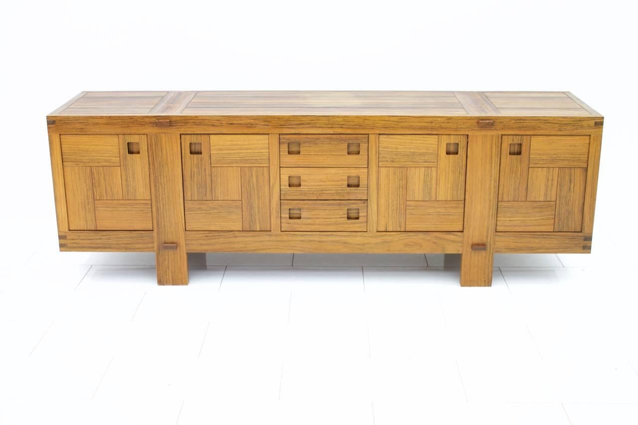 Fantastic solid Amazaque sideboard from the 1960s. Four doors and four drawers. Very good condition with small repairs on the top, please see the pictures. 
A very heavy sideboard with a fantastic look.

We offer worldwide shipping to your doorstep.