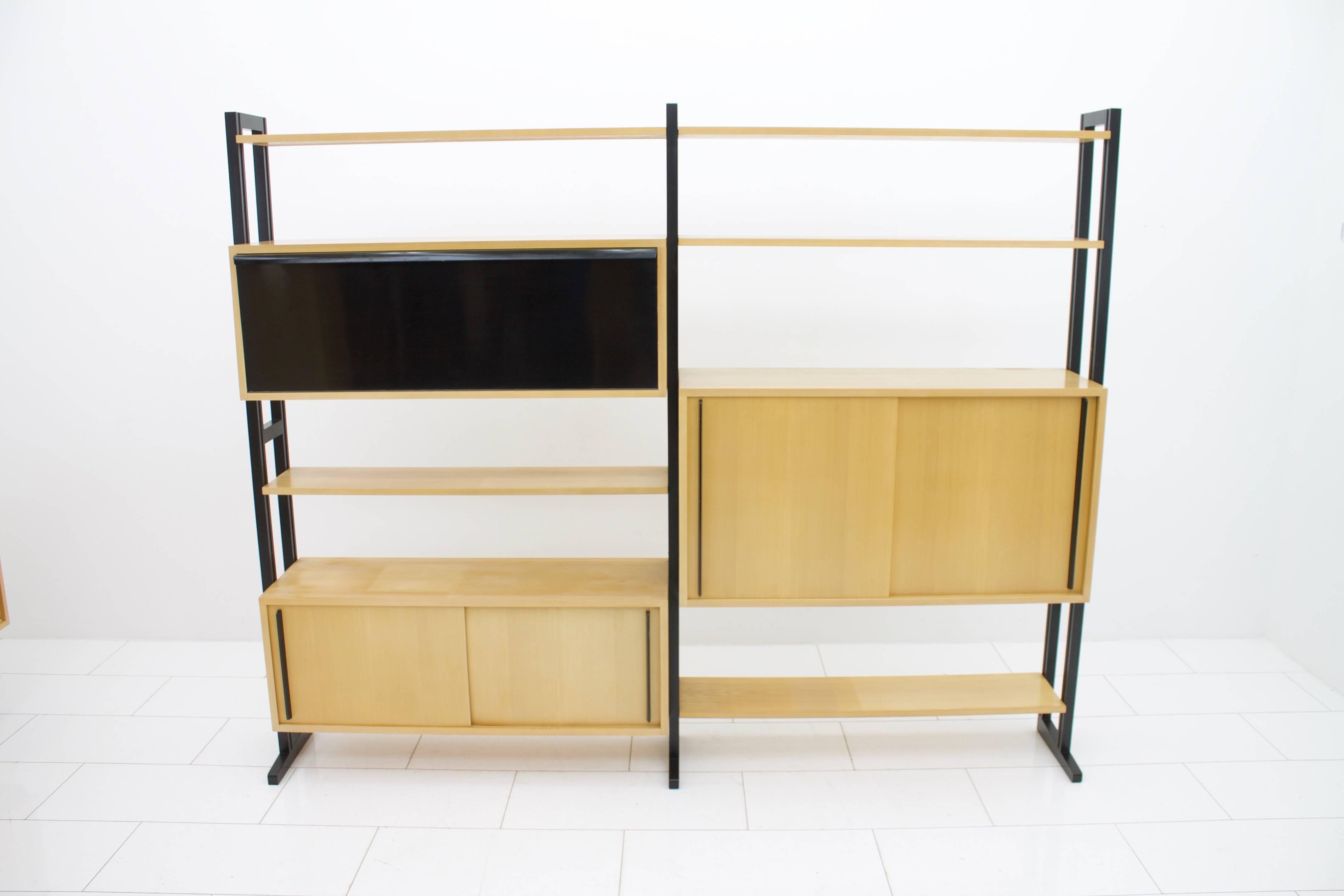 Very rare freestanding shelf system by Alfred Altherr for Freba Switzerland 1955.
cherrywood veneer with black lacquered wood grabs and holder. This shelf can be used as a room divide. The small cabinet has sliding doors on both sides.
Measure: W