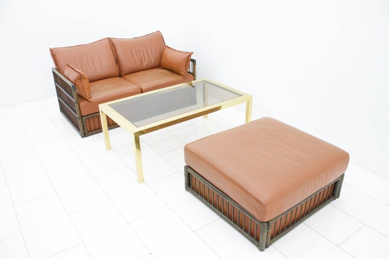 German Two Person Leather Sofa and Foot Stool with Rattan For Sale