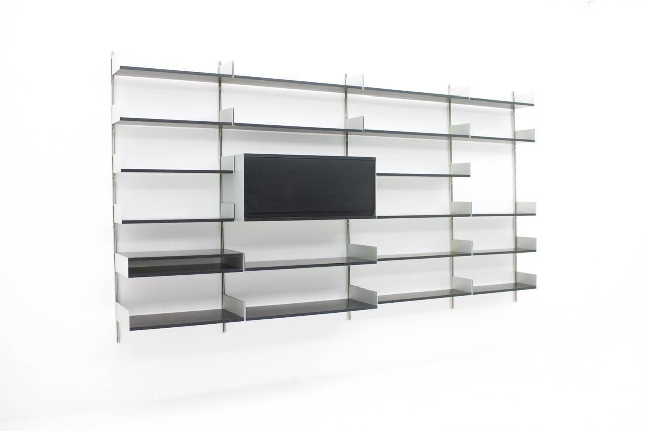 Black shelf system 606 by Dieter Rams, Vitsoe, 1966.

Measures: Nine shelves 66 x 22 cm
One shelf 66 x 36 cm.
One small cabinet 66 x 36 x 11 cm
Eight shelves 90 x 22 cm
Two shelves 90 x 36 cm
One cabinet 90 x 36 x 40 cm.
Five