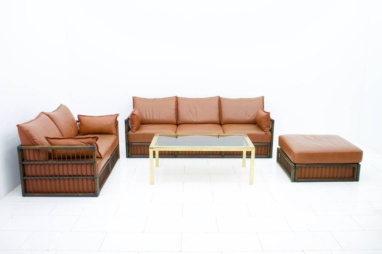 Late 20th Century Two Person Leather Sofa and Foot Stool with Rattan For Sale