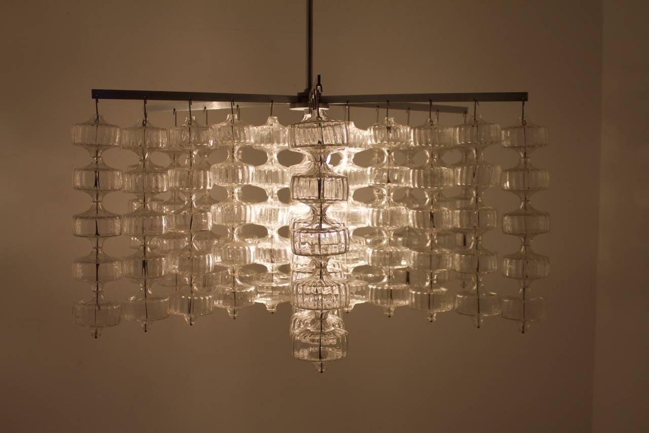 Very rare and large Chandelier by Aloys Gankofner, Germany 1965.
150 handblown glasses in total on 6 steel arms. 

We have two of this chandeliers in stock.

Diameter 117 cm, height 54 cm, height with rod 111 cm.

Very good condition.



 