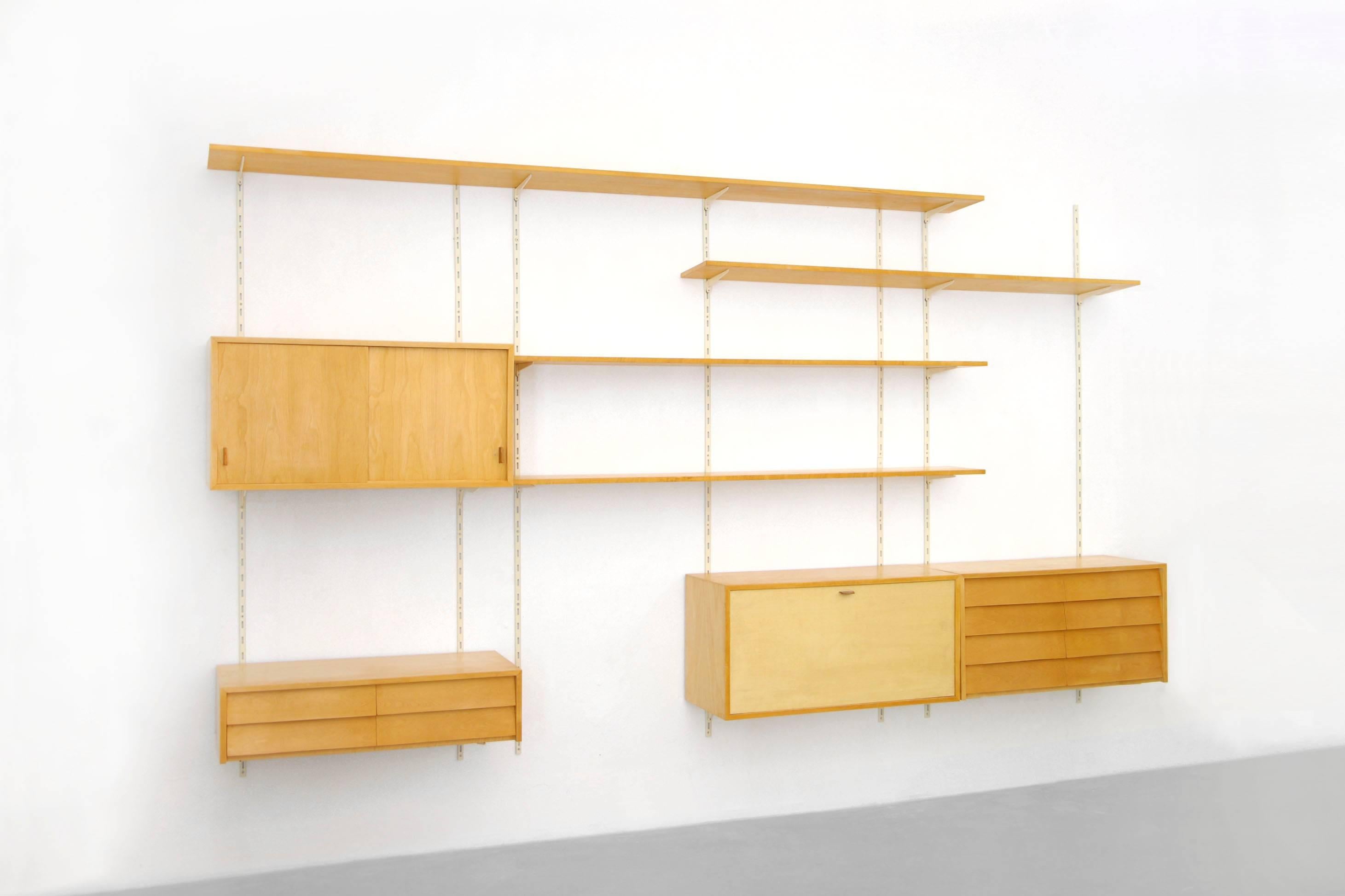Rarely seen shelving system by Florence Knoll.
This system can be arranged in different variations.
The condition is good, despite age and use. The clapdoor cabinet was restored.
We have five small shelves in stock which are on top to this offer.