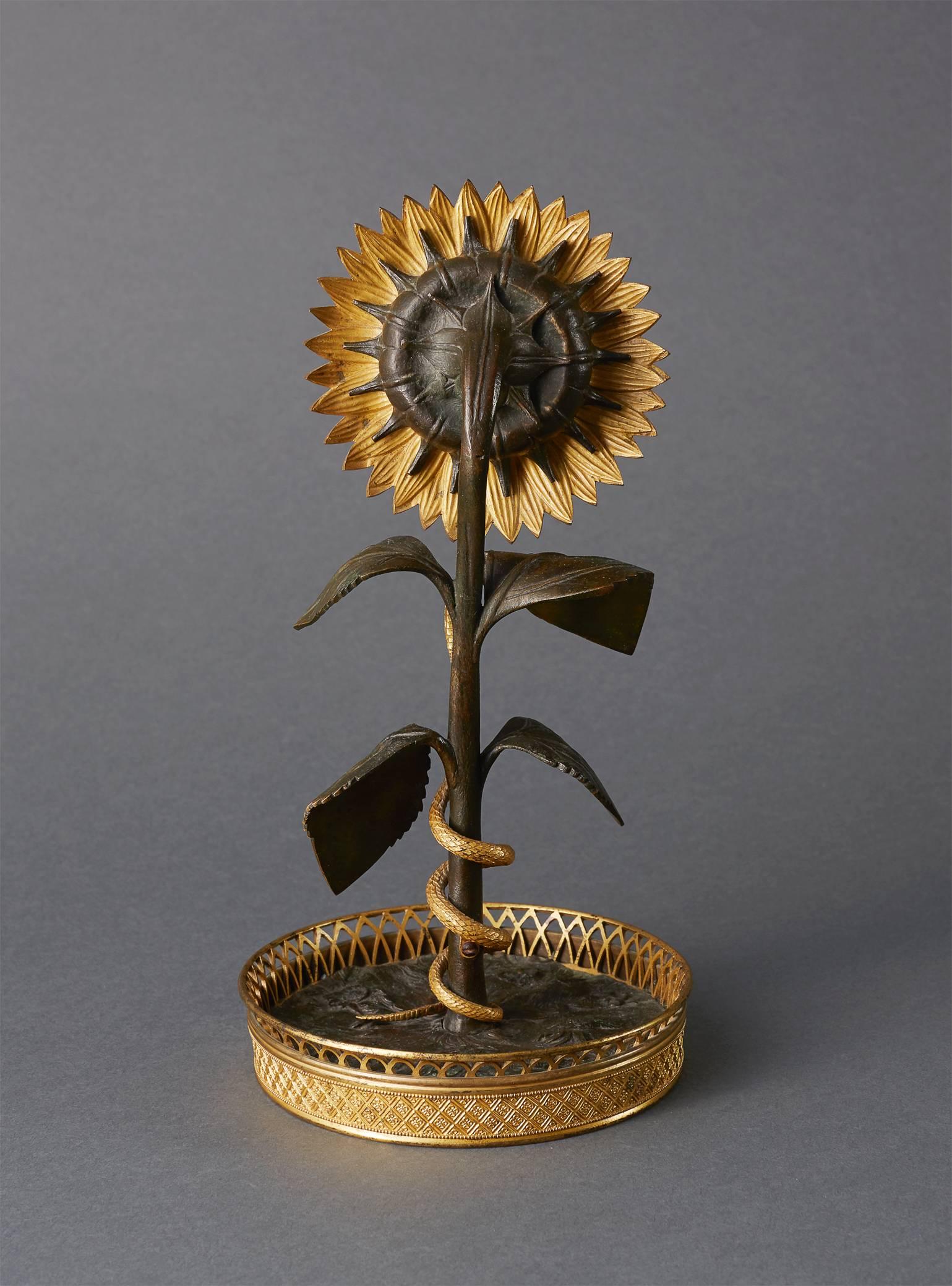A very unusal and amusing clock from the early 19th century. Attributed to the esteemed bronzier Louis-Isidore Choiselat (1784-1853) known as Choiselat-Gallien. The naturalistically cast sunflower with a detachable bezel inset with a fine watch