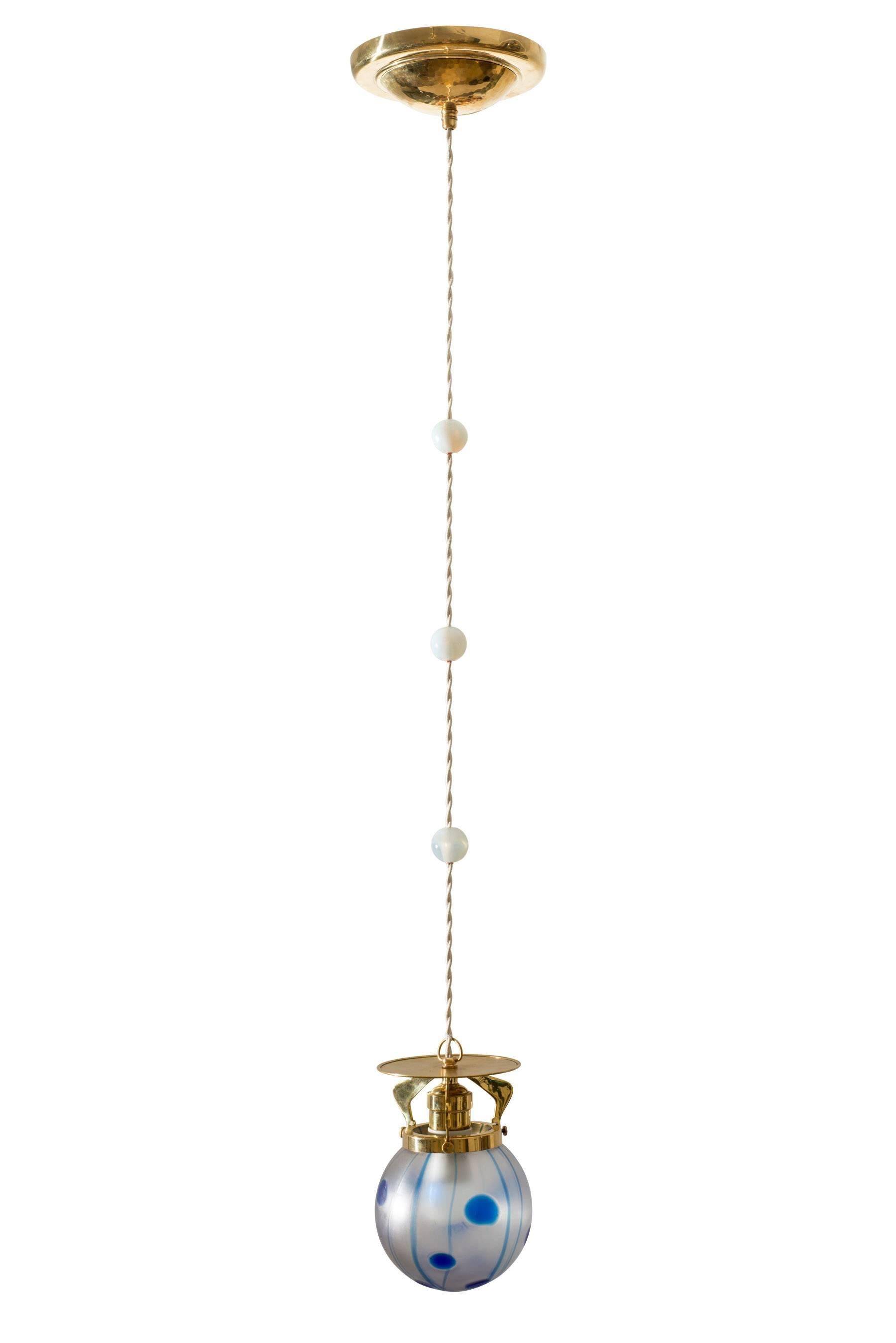This hanging lamp was executed circa 1902 in the typical “Wiener Jugendstil” and is in a very good condition. The three glass orbs are a common style element of the Wiener Jugendstil and can be found on some contemporary photographs of hanging
