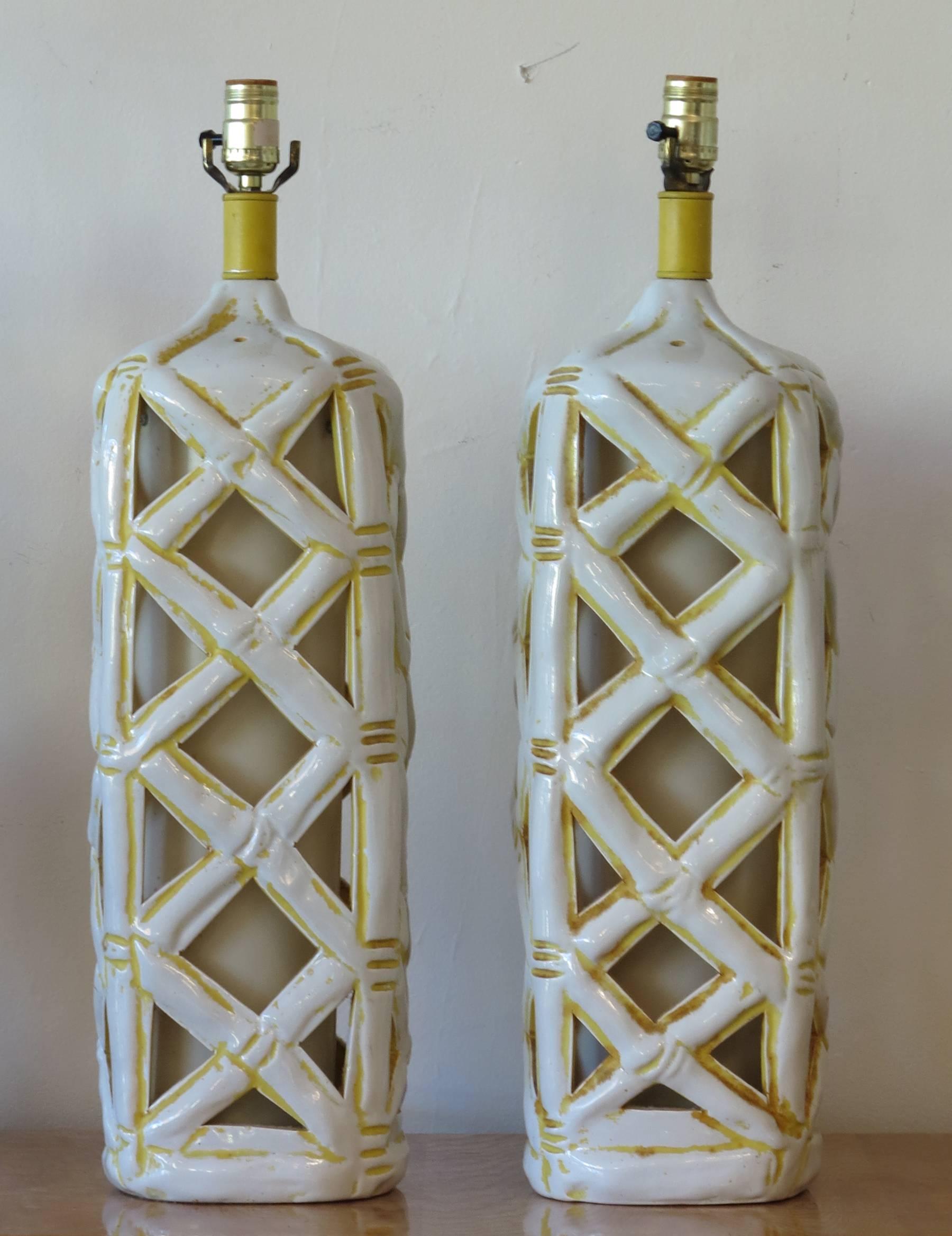 Hollywood Regency style faux bamboo ceramic lamps. 1960s Billy Baldwin Palm Beach style. Has an interior shade that lights the base. 26 inches tall to top of socket.