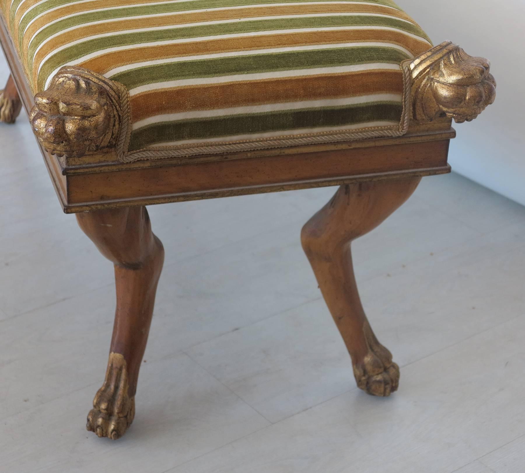 Foot of the bed bench or decorative overflow seating. Striped upholstered top is in excellent condition. Retains the original finish in intact condition.