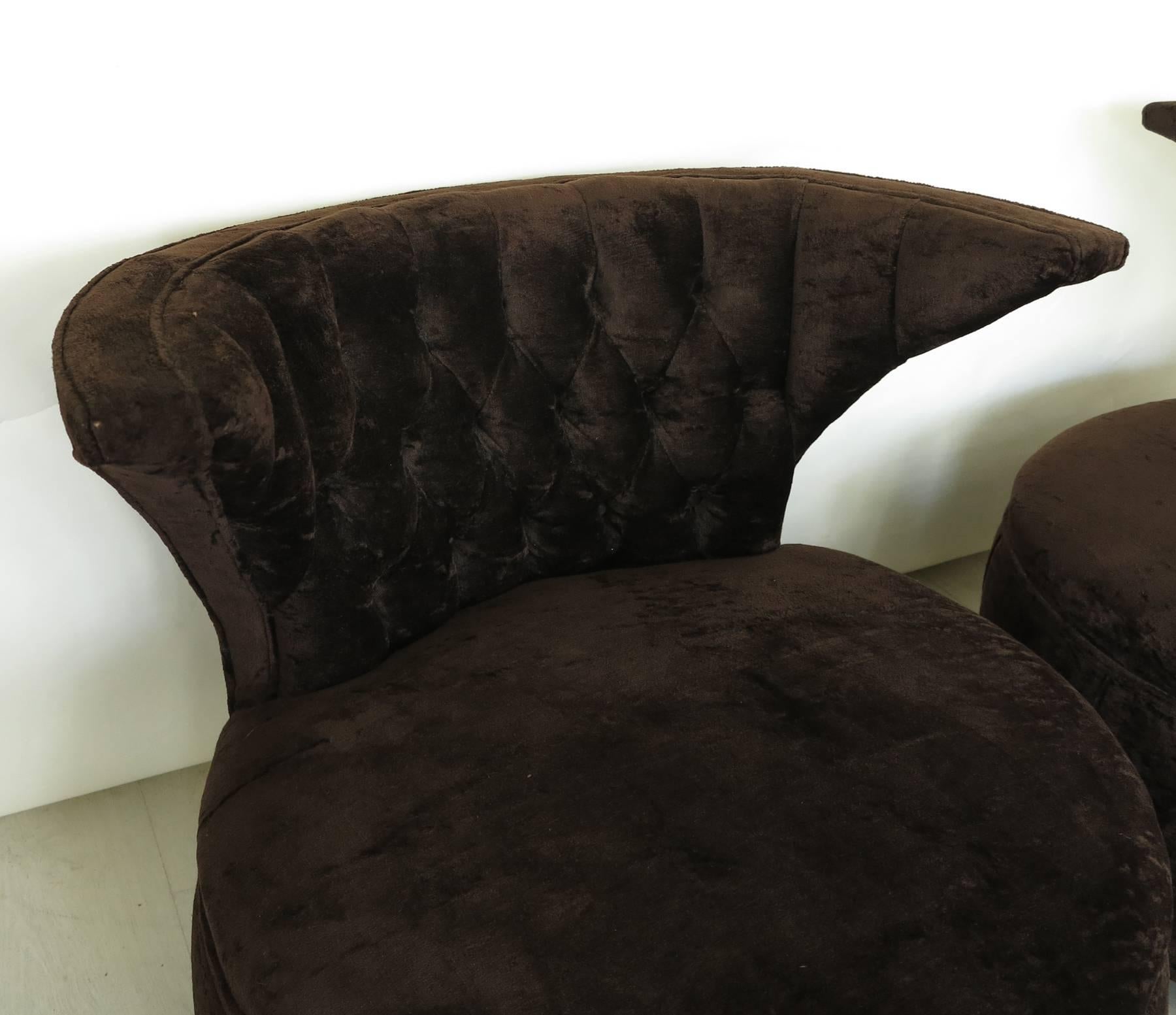 Pair of barrel lounge chairs tufted backs with wrap around wings. Original chocolate colored crushed velvet upholstery. Overall in very good condition.