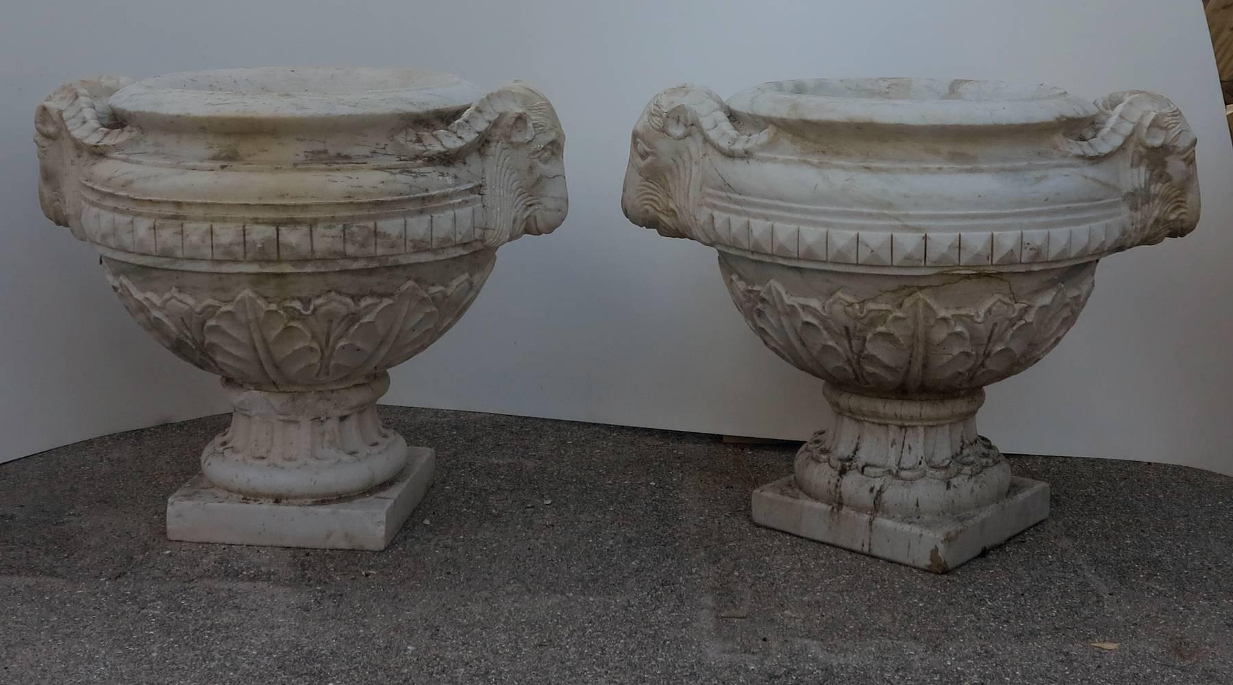 Large beautifully carved 19th century marble urns. Statement piece to a grand entryway. Condition consistent with age and wear. Loss to one of the pedestal bases. See photo. Measures approximately 25