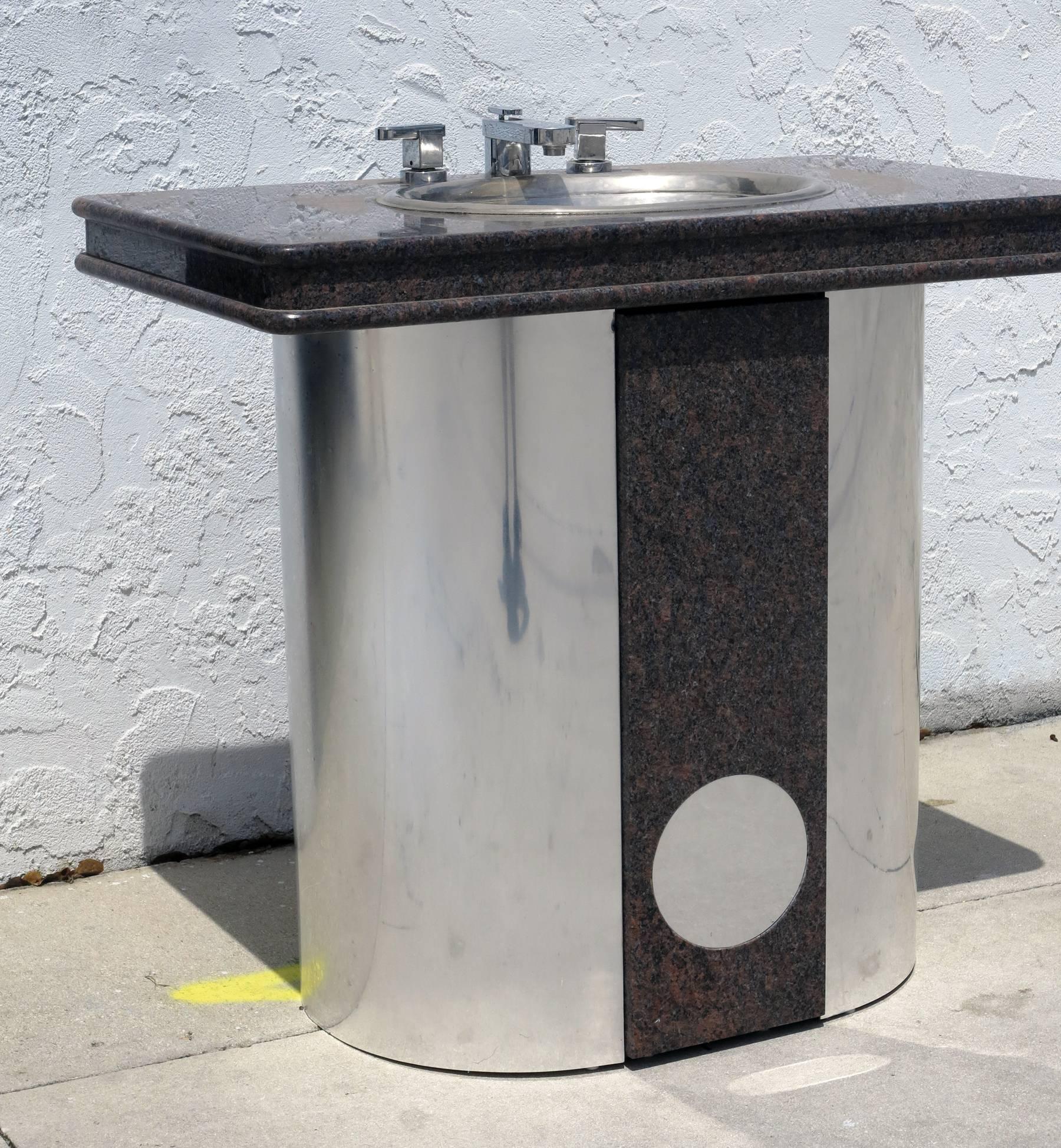 Vintage Sherle Wagner vanity sink black granite top with stainless steel base. Polished aluminum sink with chrome fixtures.