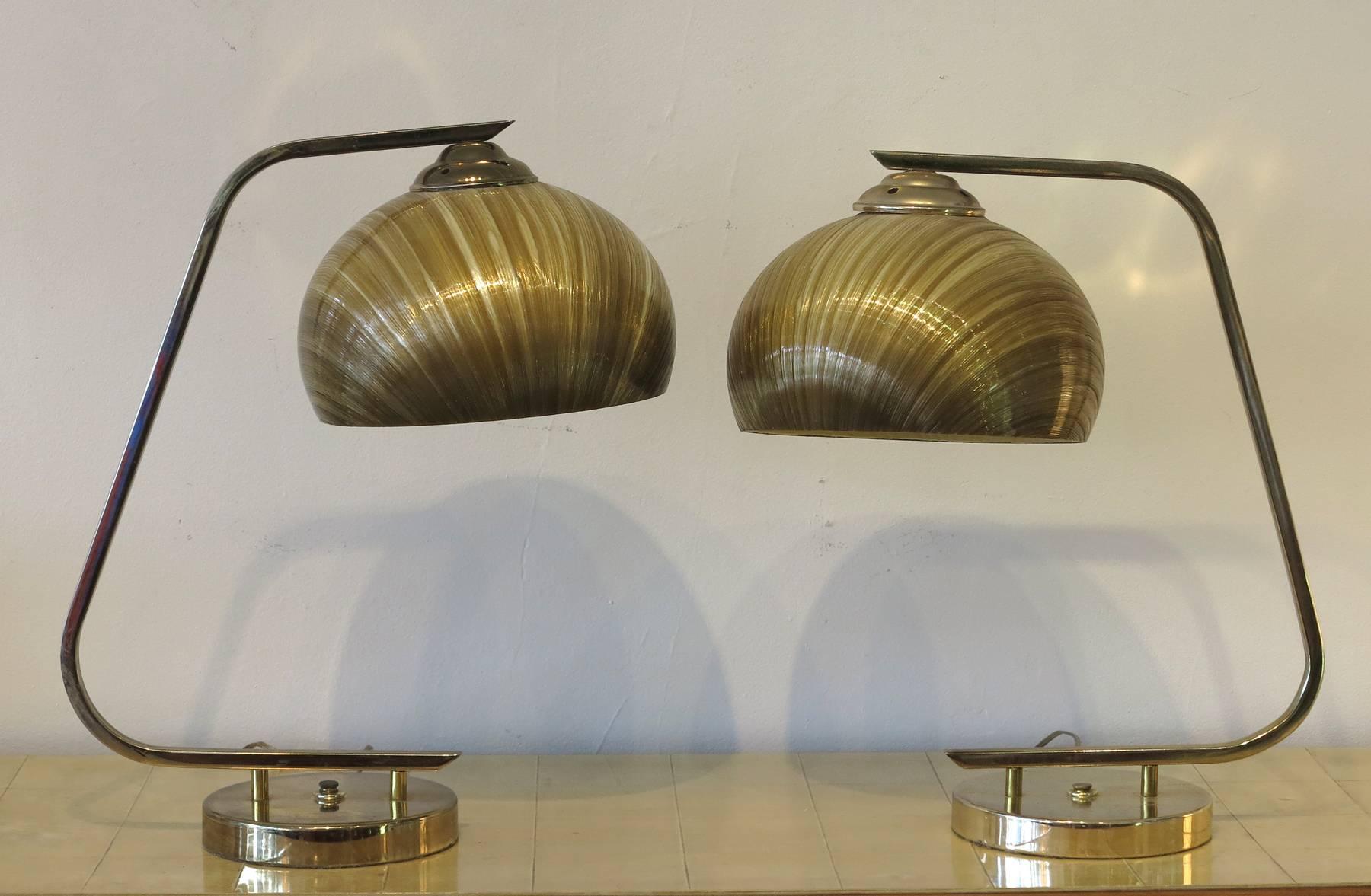 Vintage 1960s spun fiberglass shades brass bases. Have a pleasing glow when lit.
