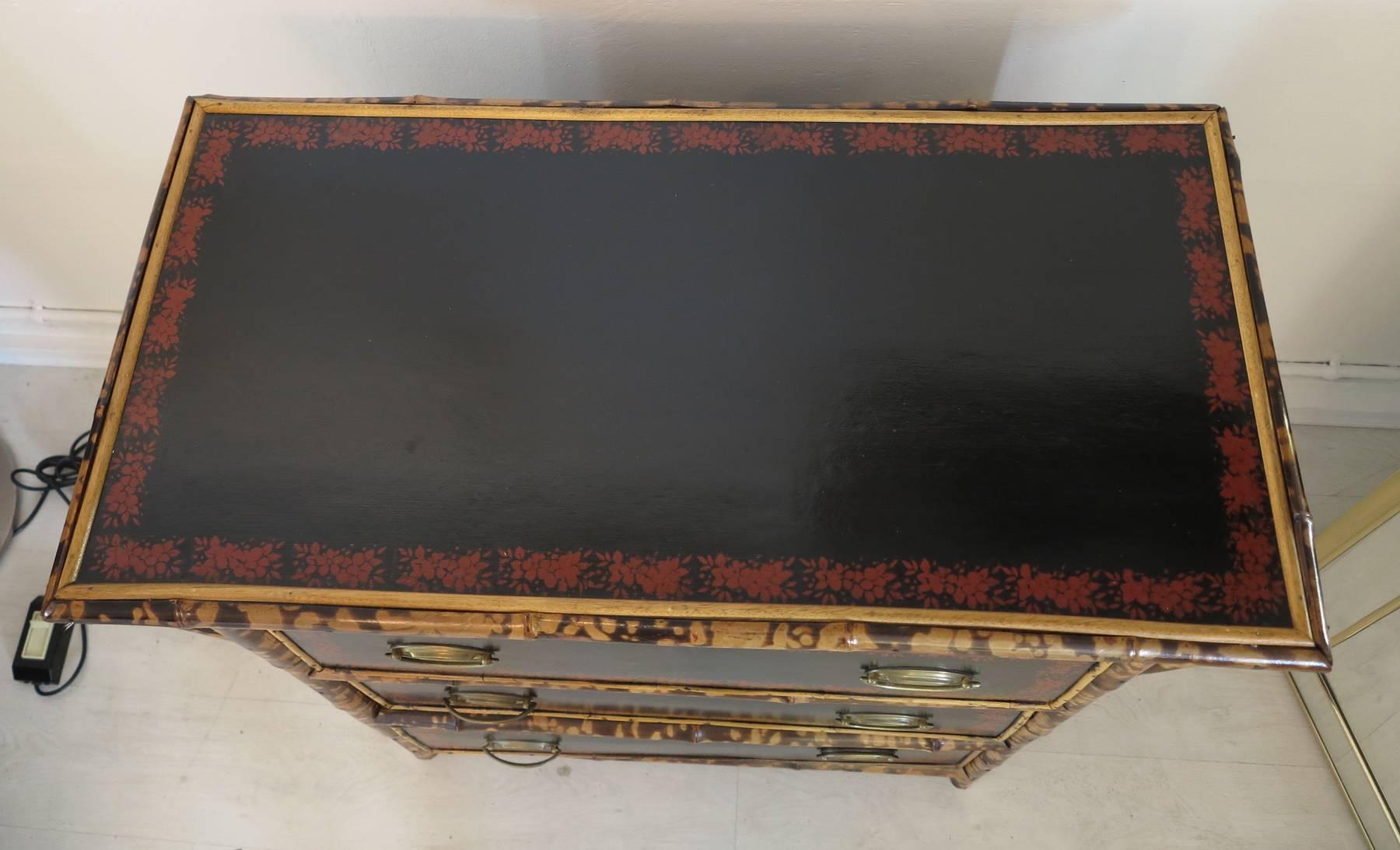 Three drawer bamboo dresser from the late eighteen hundreds. Repainted panels in the typical style of the day with anaglypta paper sides. 