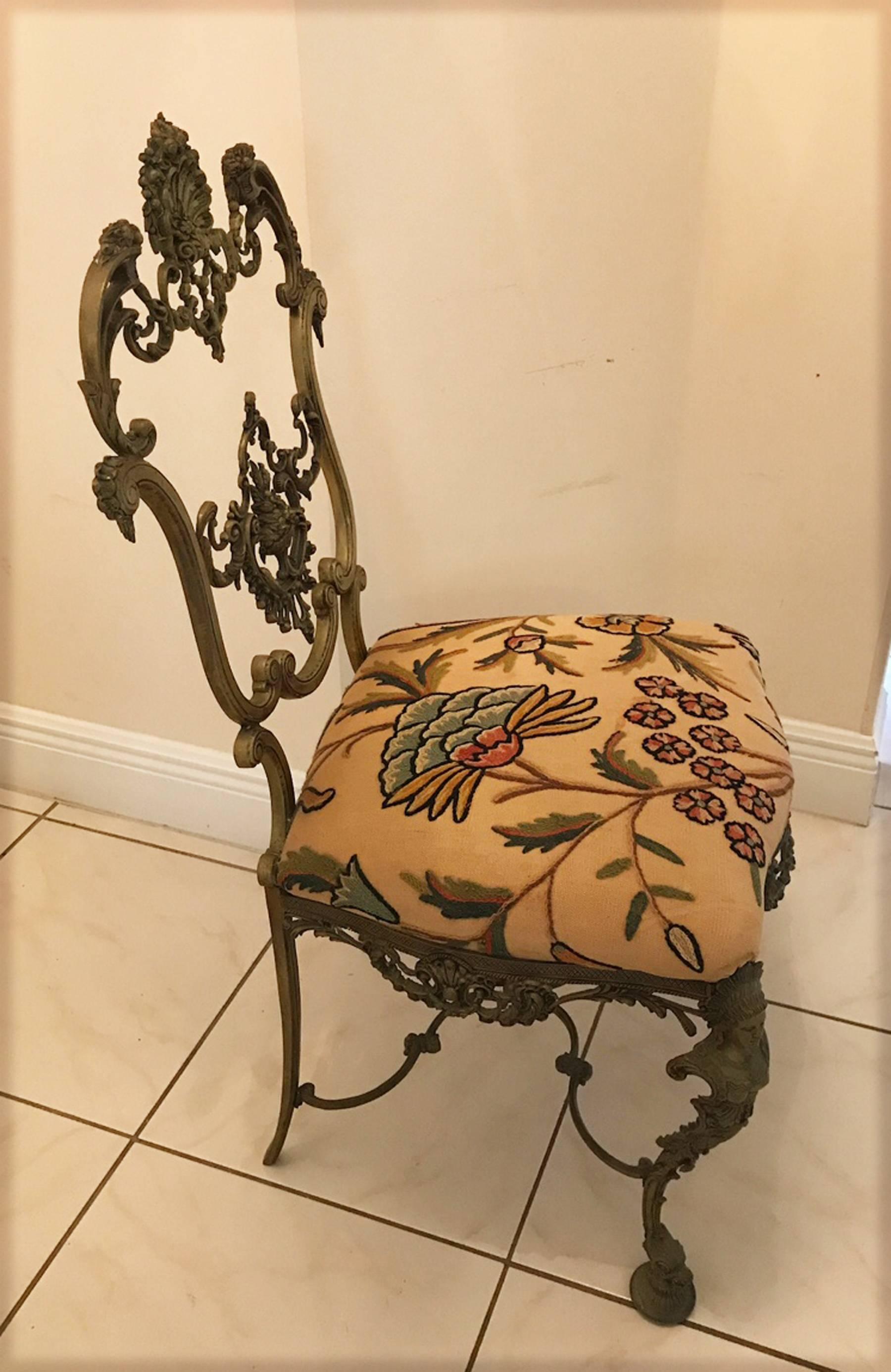 Highly detailed cast bronze side chair. Has the look of the Italian cast brass chairs of the 1960s and 1970s. Very unique chair stamped into the bronze made in Spain. Crewel work on the seat in very good usable condition.