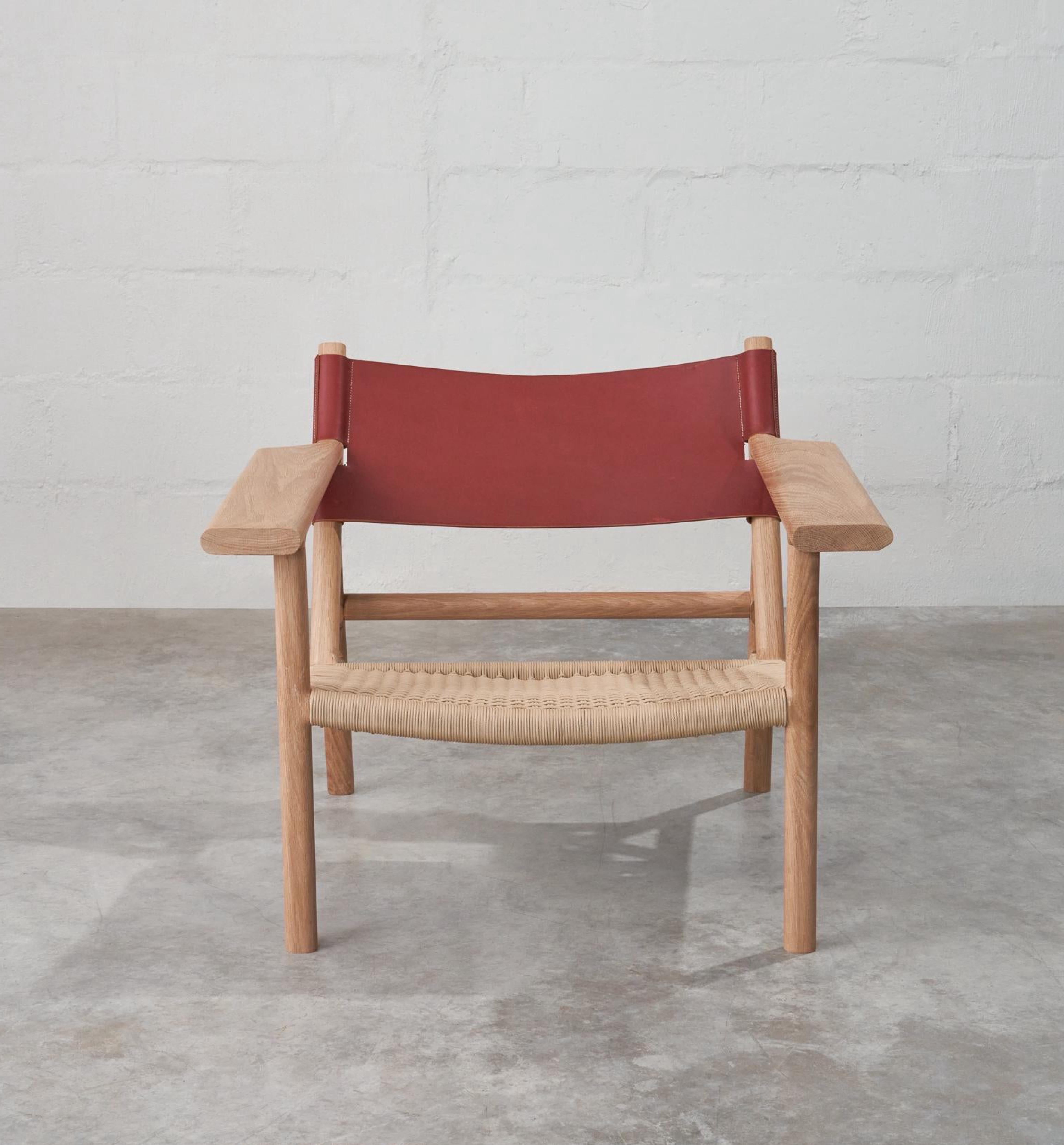 The Kruger chair has a strong presence with its solid oak construction, full grain leather backrest and woven seat. The wide armrests are a nod to Børge Mogensen’s Spanish chair design incorporating his concept of timeless design where form follows