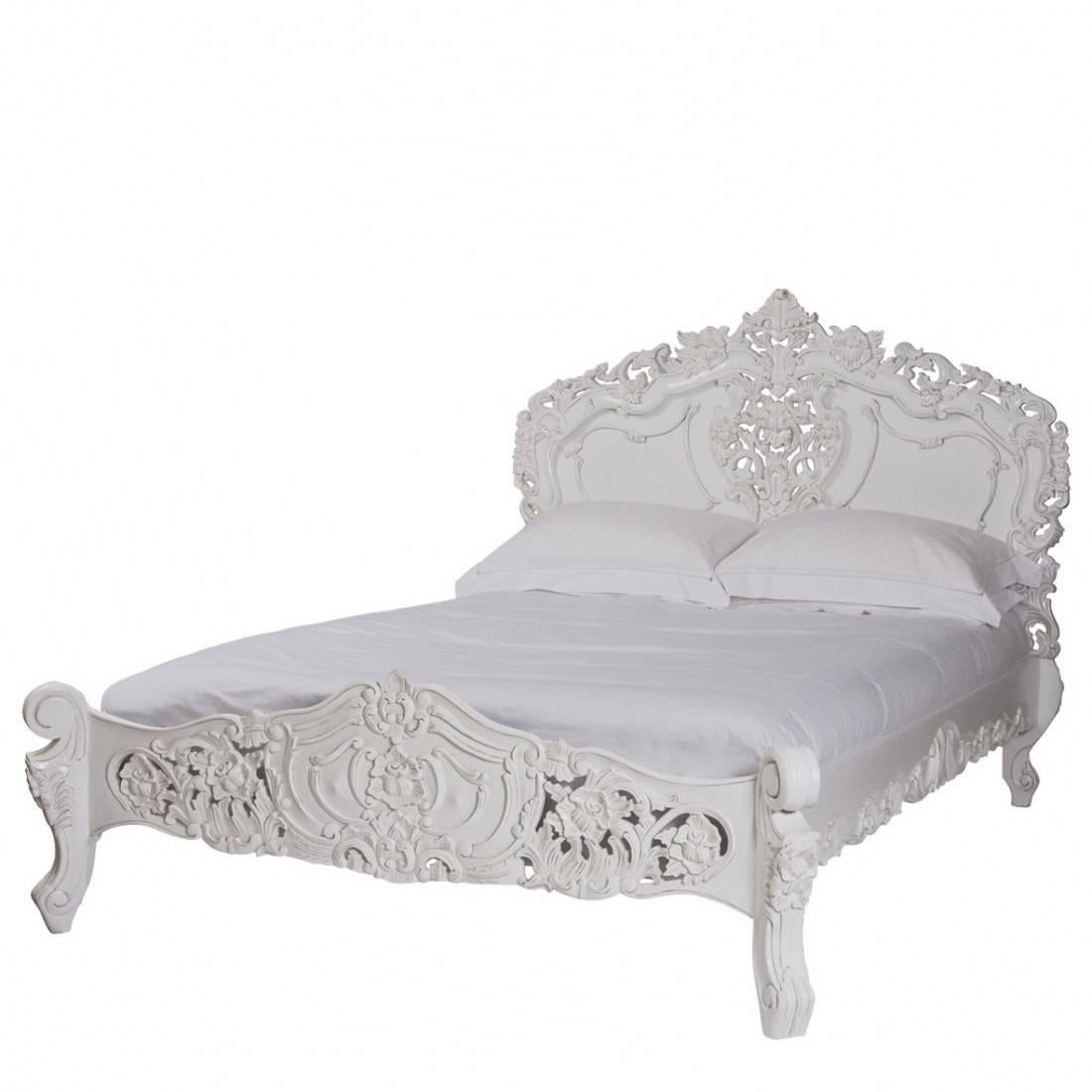 Hand carved beautiful bed in the French Louis XV Rococo Style. Solid mahogany wood. Finished in glossy white with scrumptious carvings. Will fit a standard US Queen size Mattress. Bed comes with slats to place a mattress on top. Please contact us