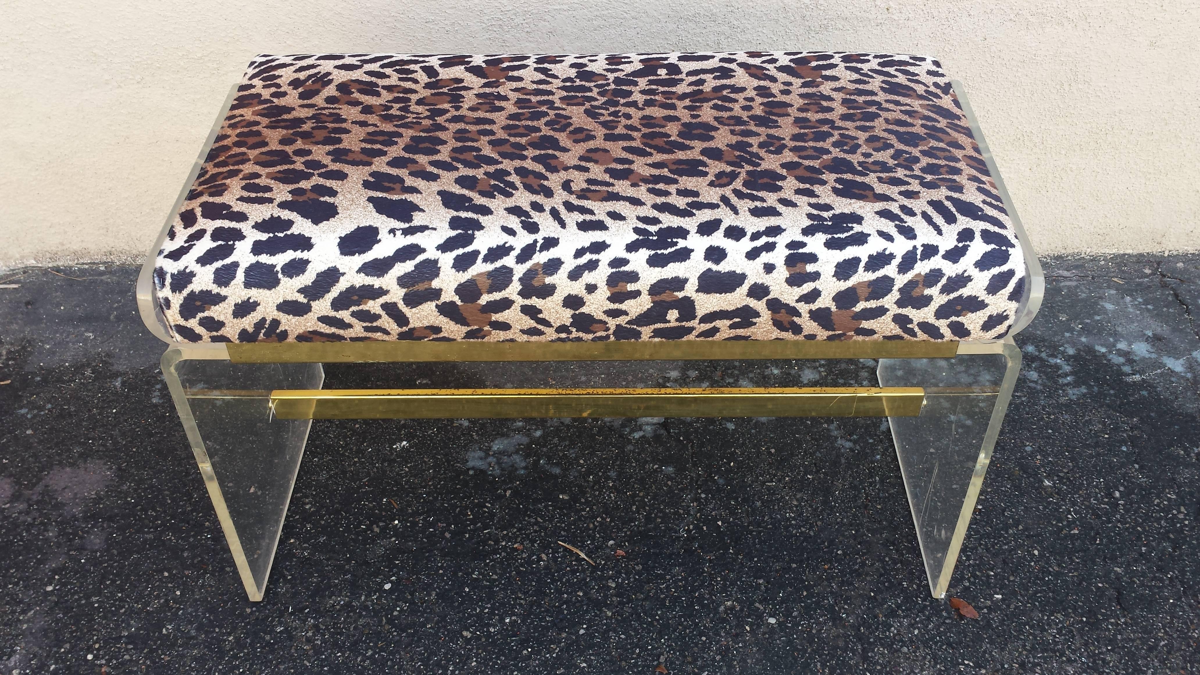 Mid-Century Lucite bench in original condition. Seat is new upholstered in leopard fabric. Dimensions: L 30