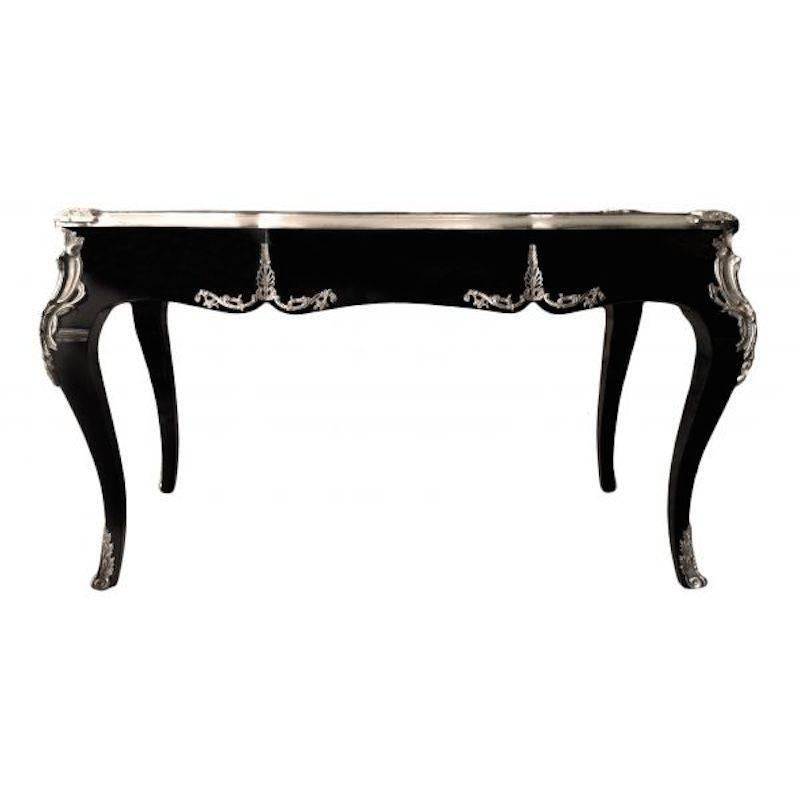 Desk is made from solid mahogany wood. The desk is new painted in black lacquer with silver trim. The top has a faux black leather inlay. Three drawers with new silver hardware. Silver bronze scrolls on the feet and the sides. This desk and be