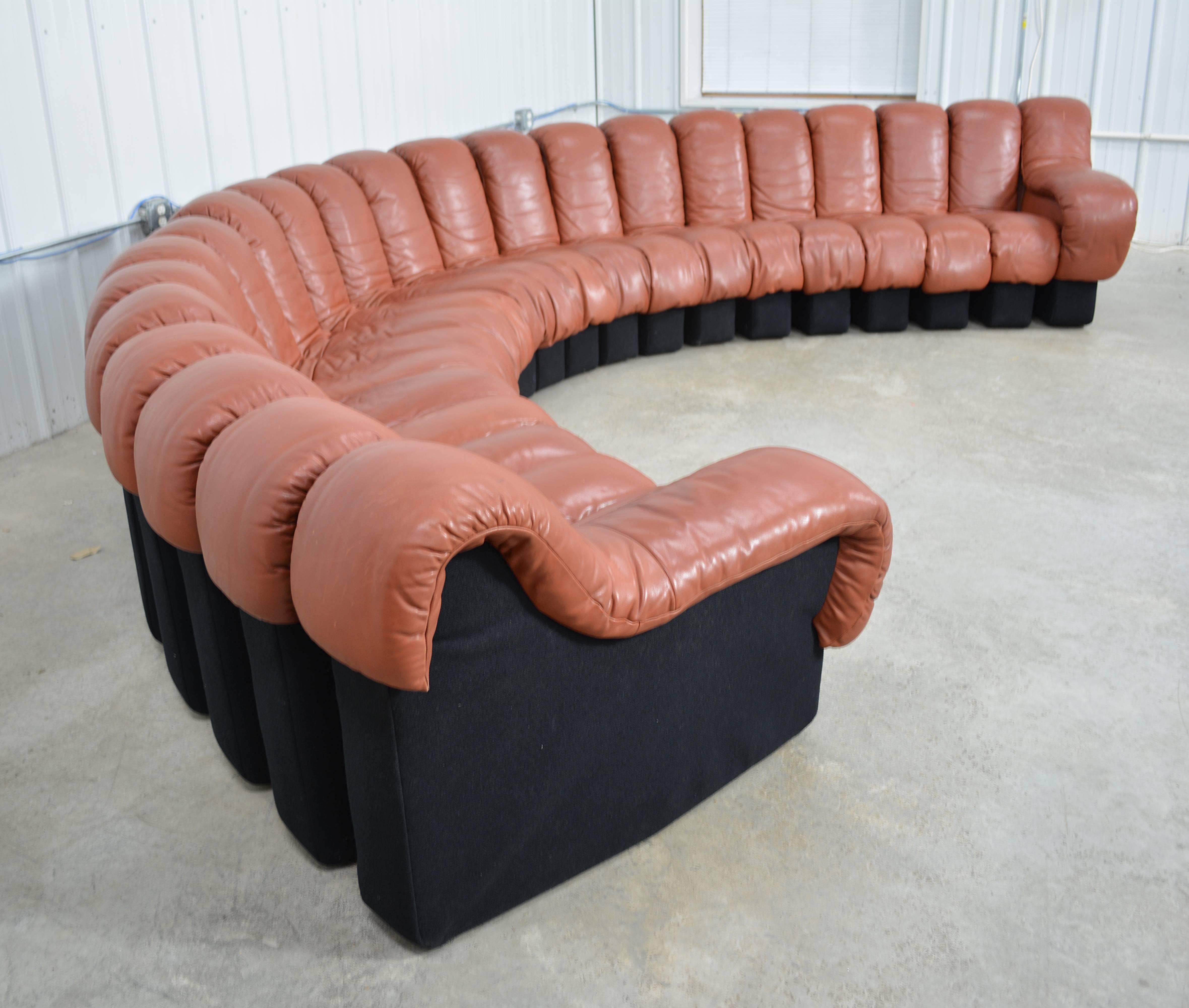 A De Sede DS600 non-stop modular sofa designed by Ueli Berger, Elenora Peduzzi-Riva and Heinz Ulrich and imported by Stendig. It consists of 22 sections that can be connected and arranged into to any shape. Original cognac leather upholstery and