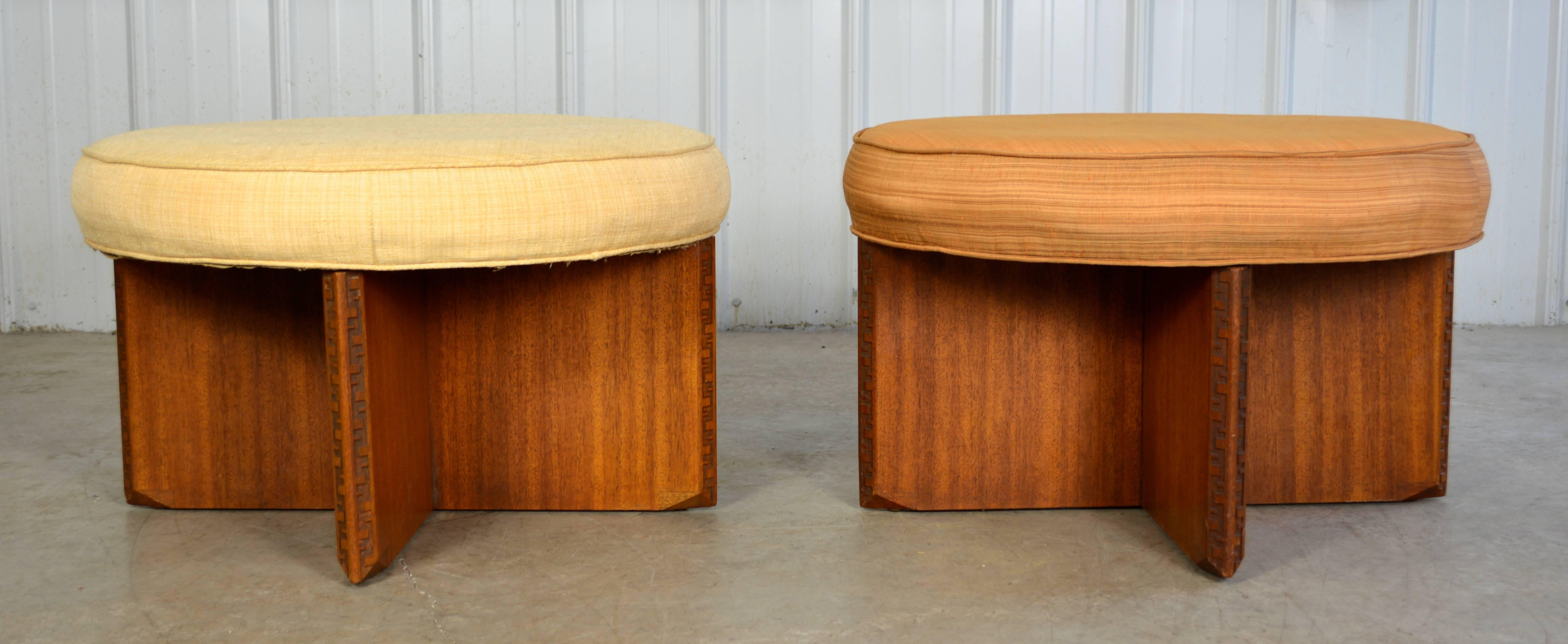 A beautiful pair of large round swiveling ottomans designed by Frank Lloyd Wright for his 