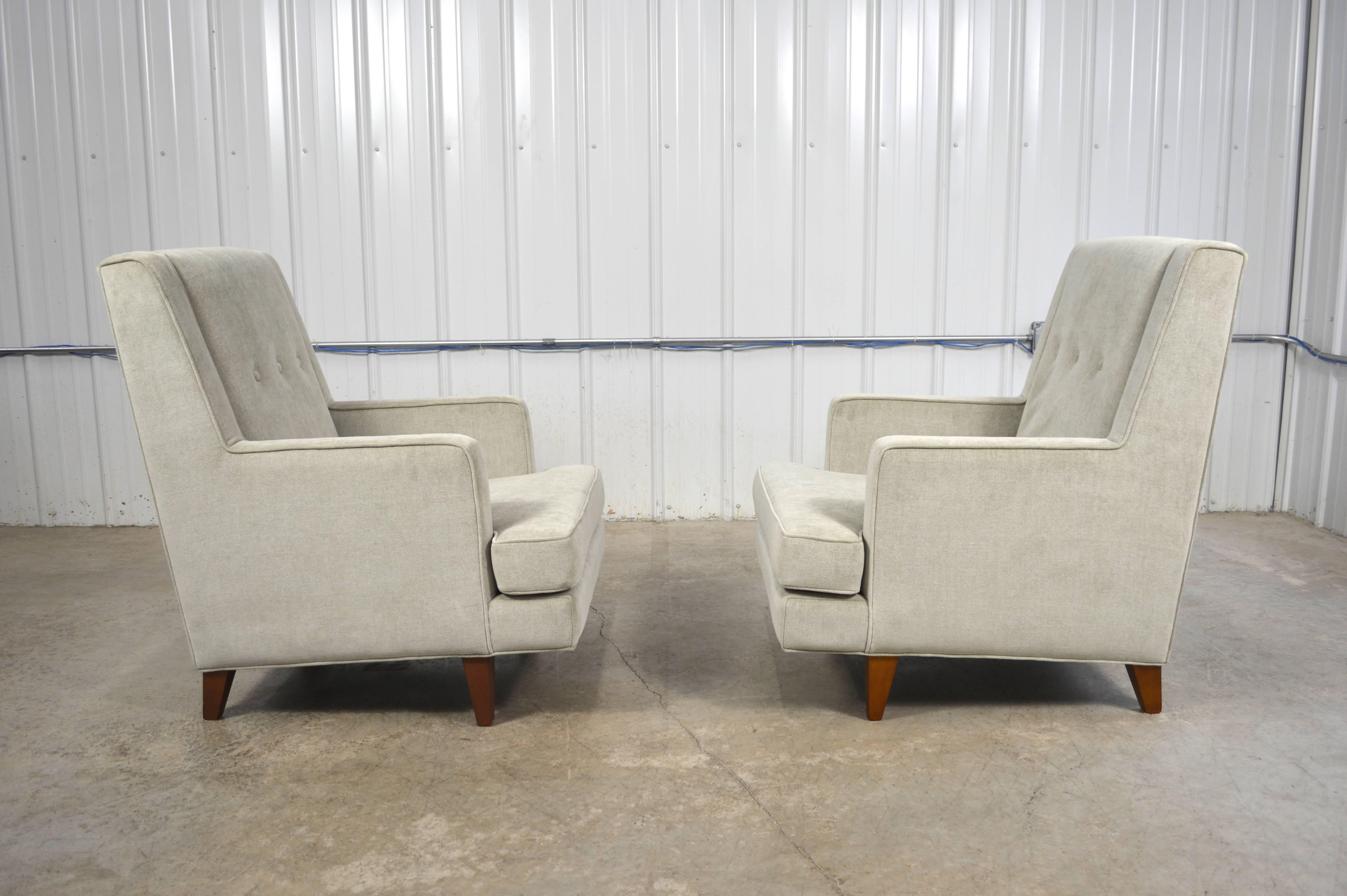 A pair of "Tall Man" lounge chairs by Edward Wormley for Dunbar. Newly restored and upholstered in a neutral fabric.