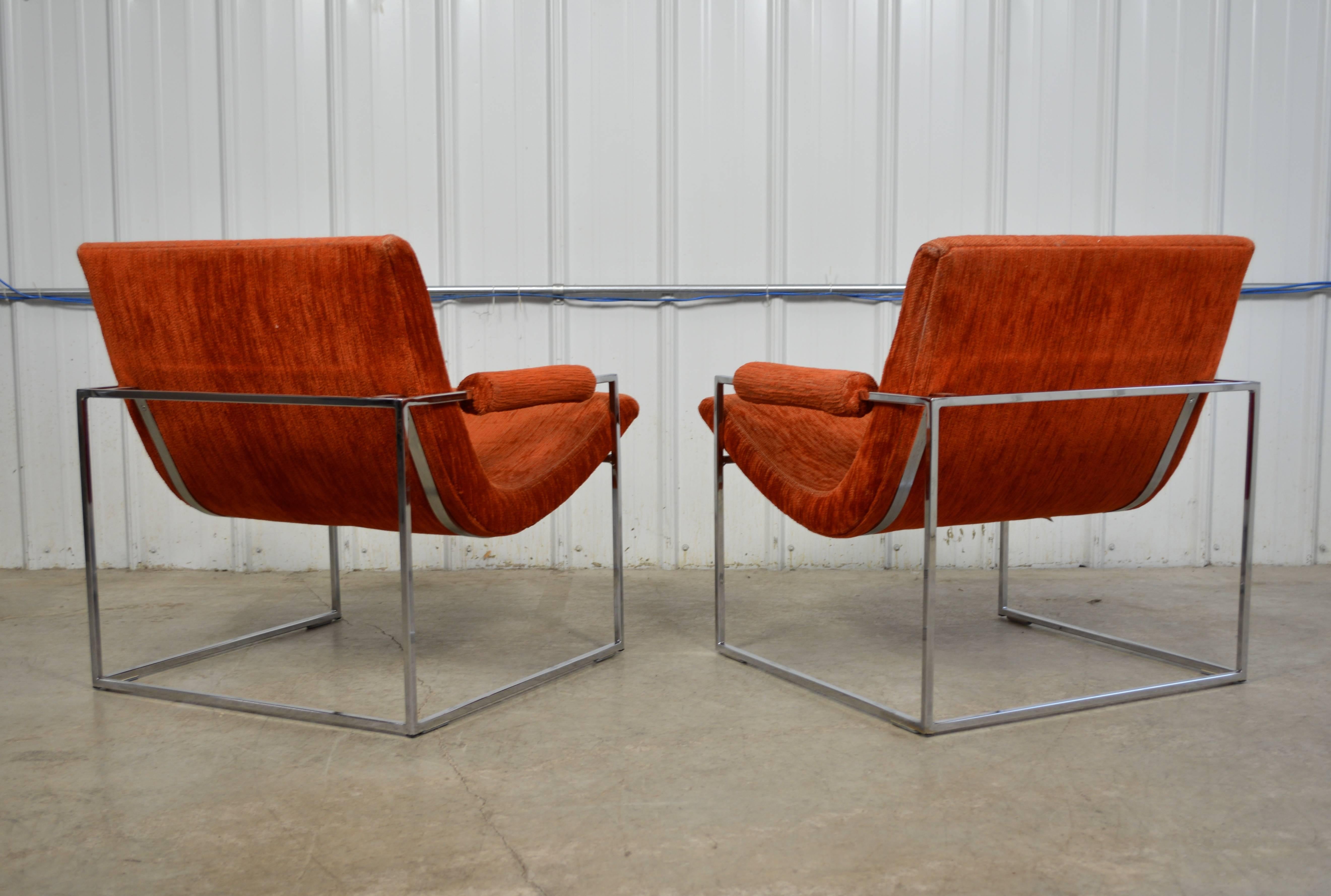 A pair of chrome frame scoop lounge chairs by Milo Baughman for Thayer Coggin. These are labeled and in all original condition. The chrome finish is excellent.