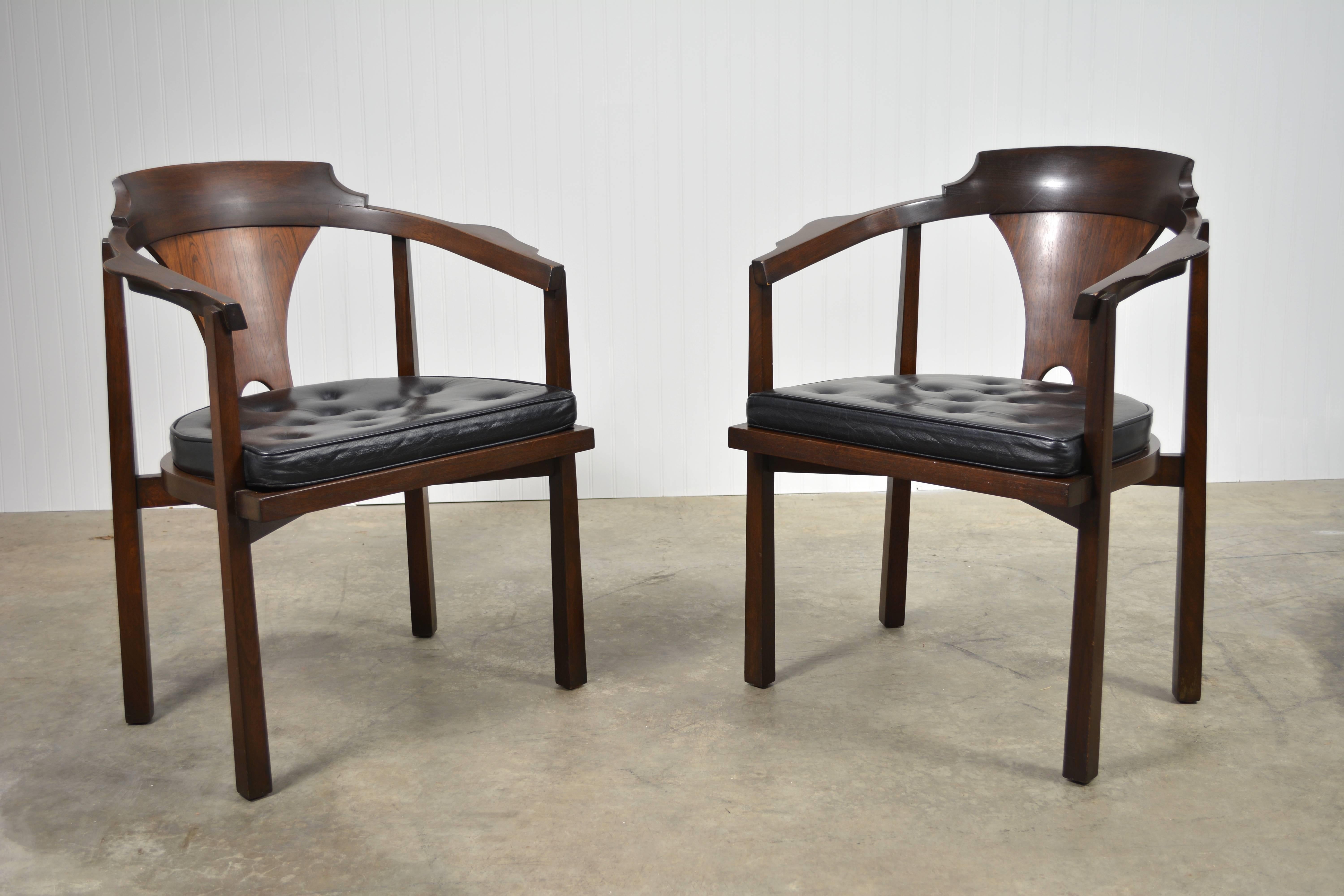 A beautifully sculpted pair of horseshoe chairs by Edward Wormley for Dunbar. Rosewood and mahogany construction. Original finish and upholstery. Available individually, as well.