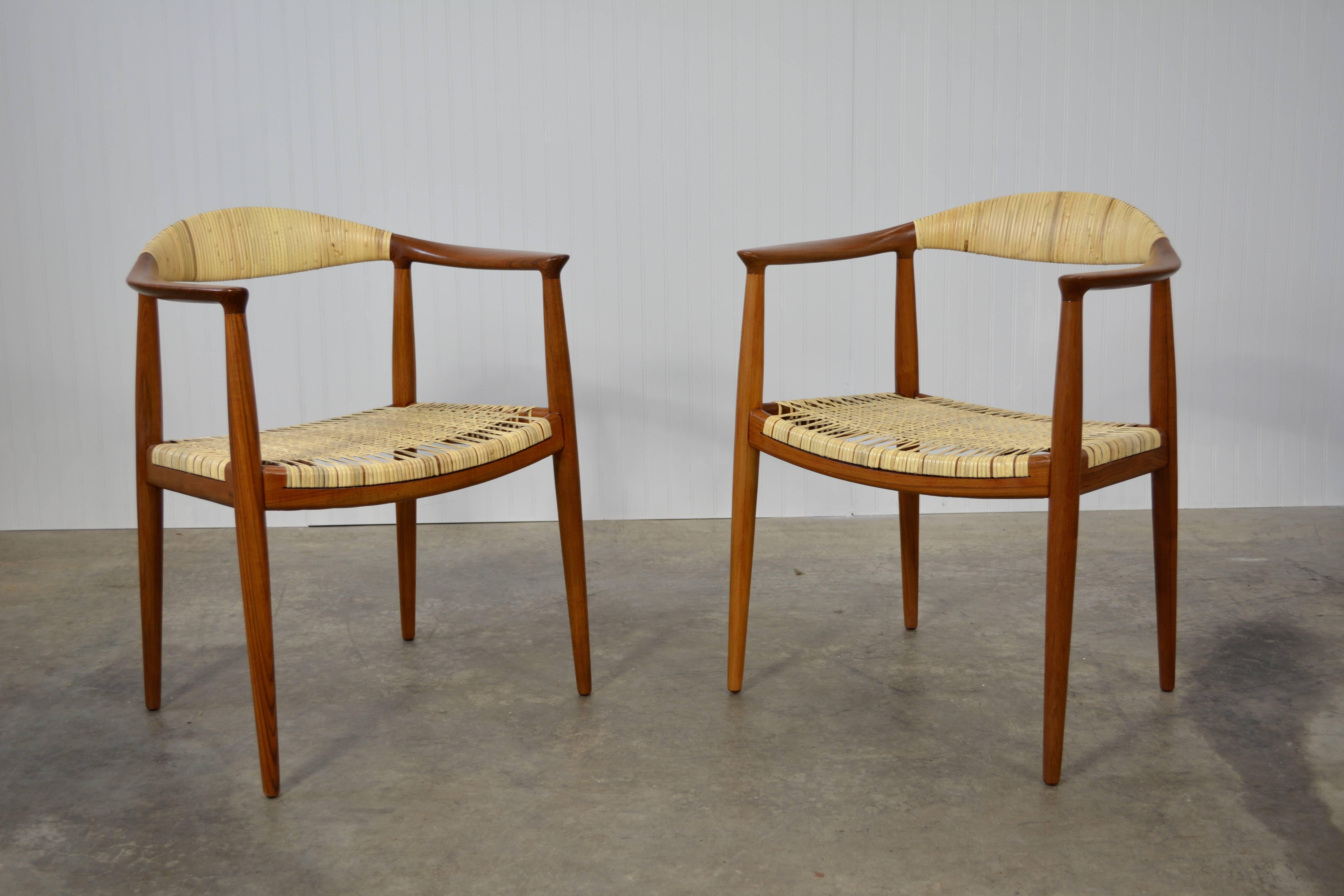 Pair of round chairs designed by Hans Wegner for Johannes Hansen. Solid teak frames with new caning on the seats on back. Both chairs stamped.