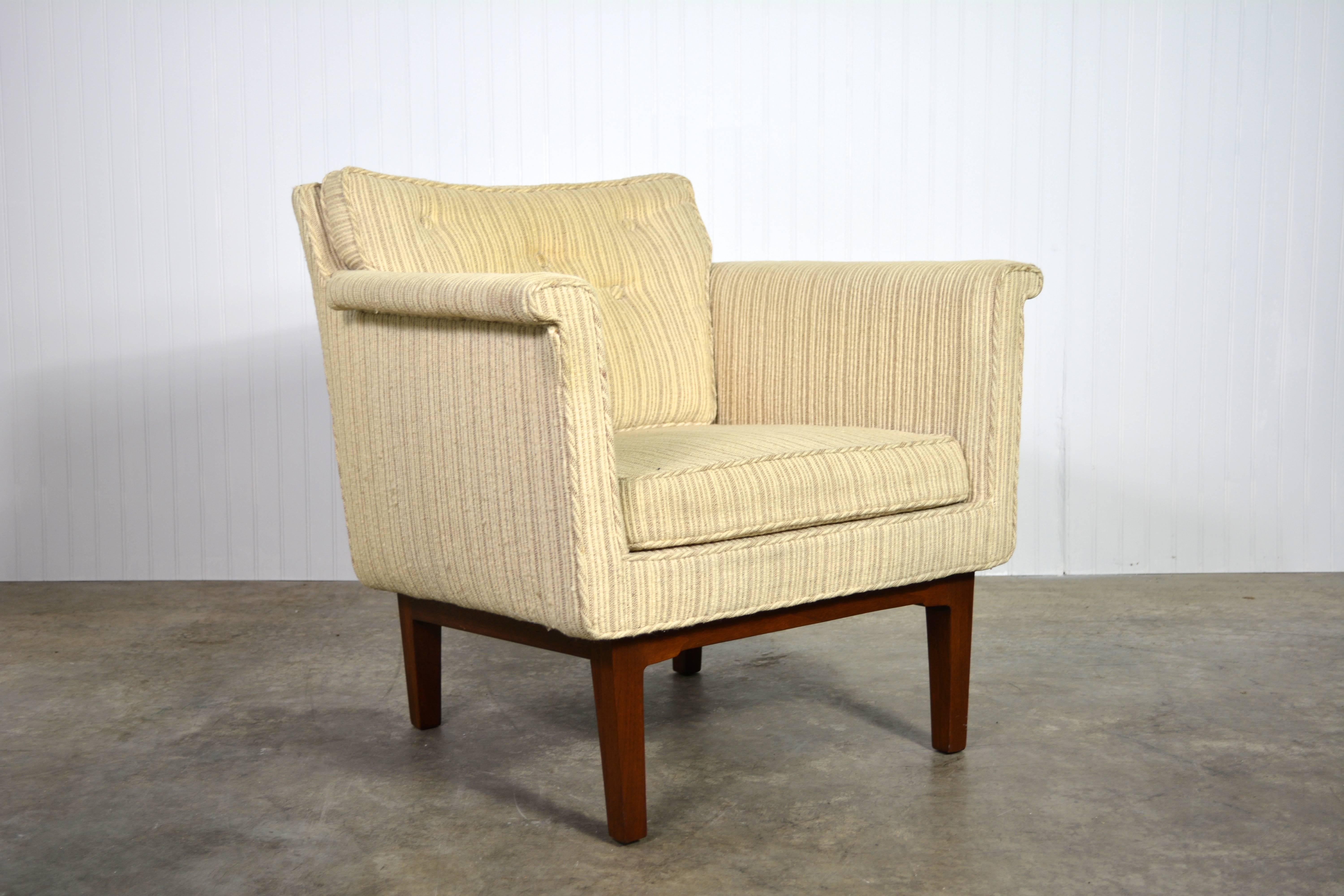 Lounge chair designed by Edward Wormley for Dunbar. Features subtle carved details in the mahogany legs and a tufted back cushion.