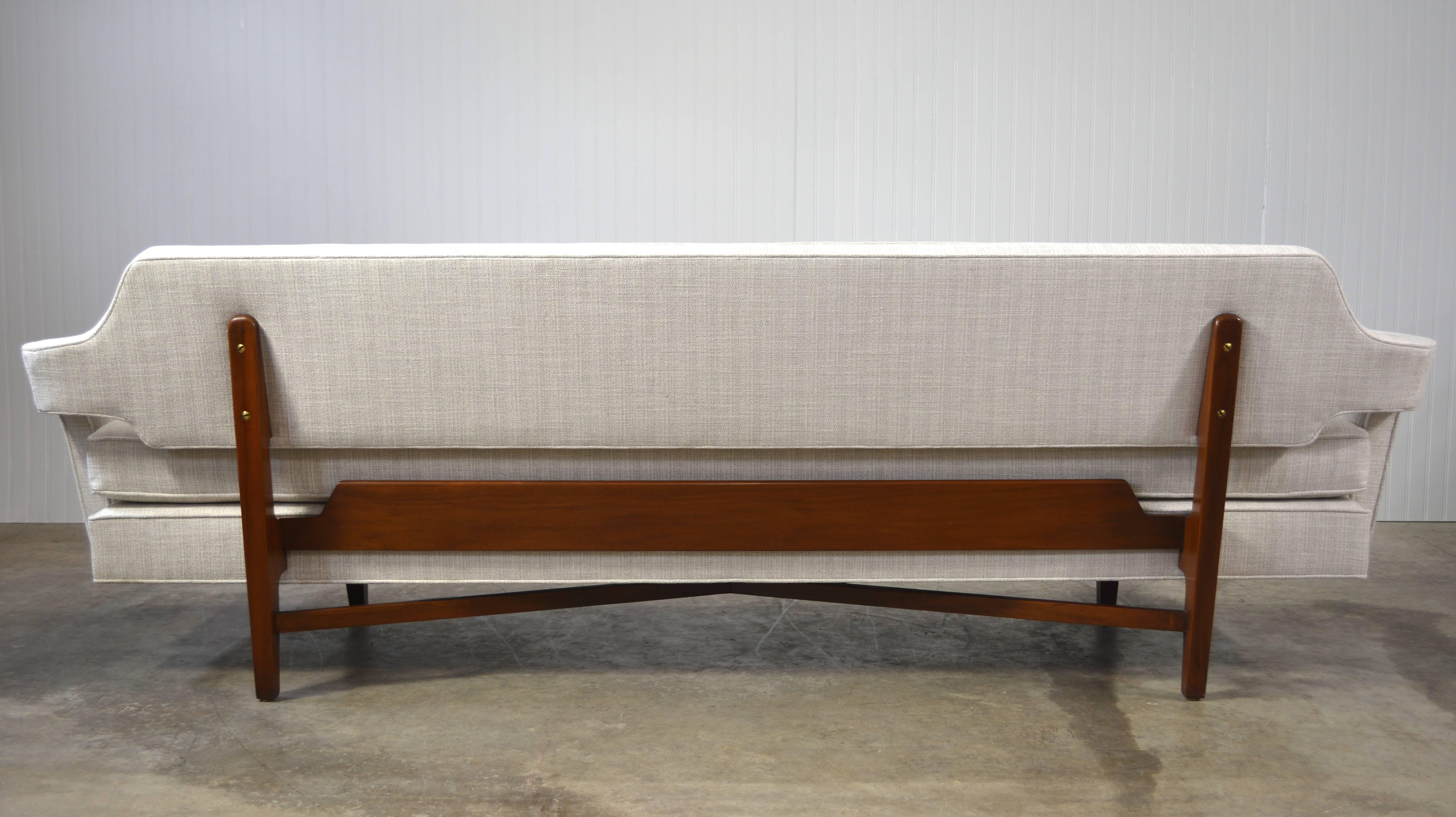 A stunning and rare pair of sofas by Edward Wormley for Dunbar. Unique bracket back and X-base stretchers. Solid mahogany frames. Newly recovered.