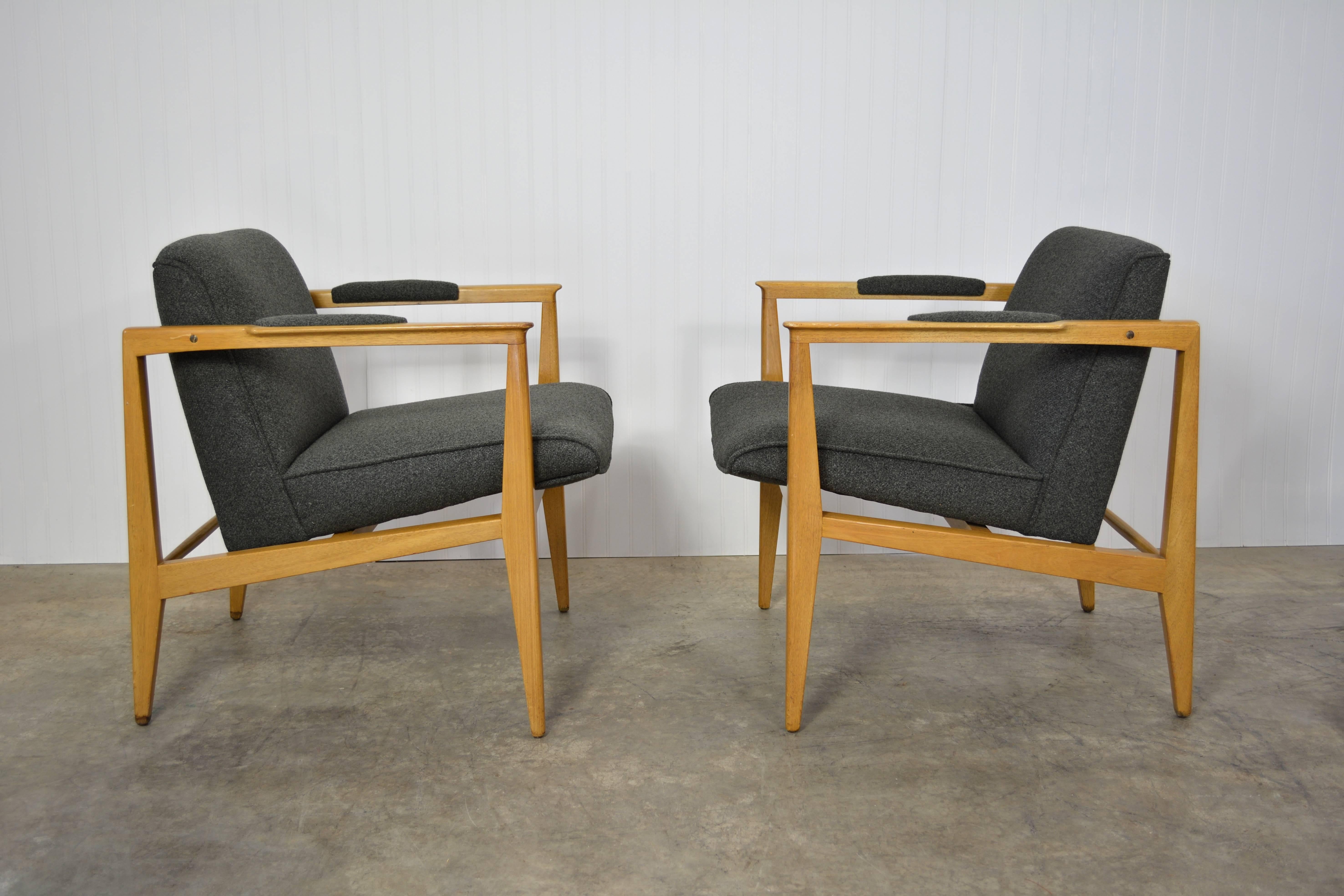 A pair of lounge chairs designed by Edward Wormley for Dunbar. Bleached mahogany frames and charcoal grey upholstery. Both chairs labeled.