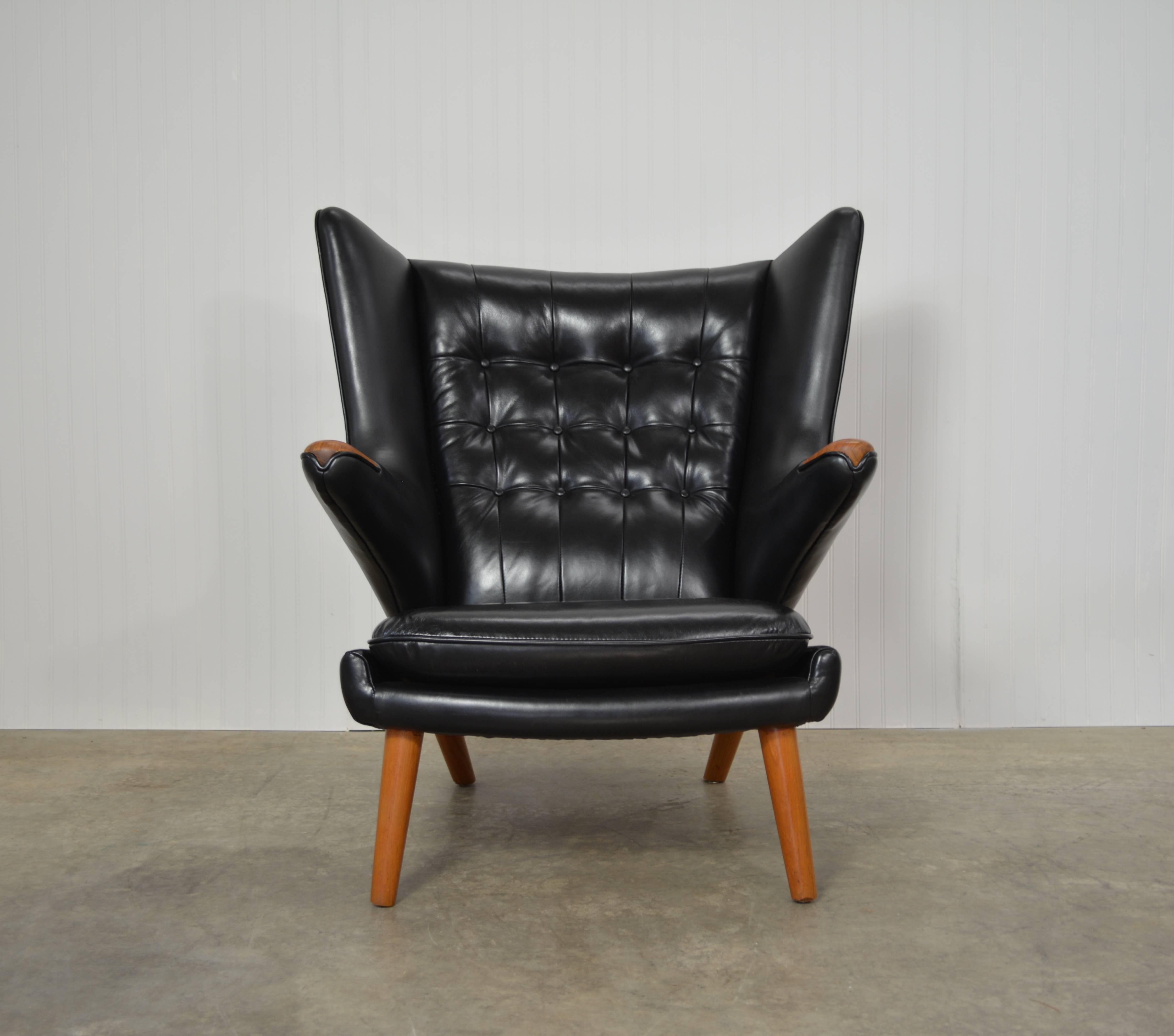 Hans Wegner Papa Bear chair. Teak legs and paws. Black leather upholstery.