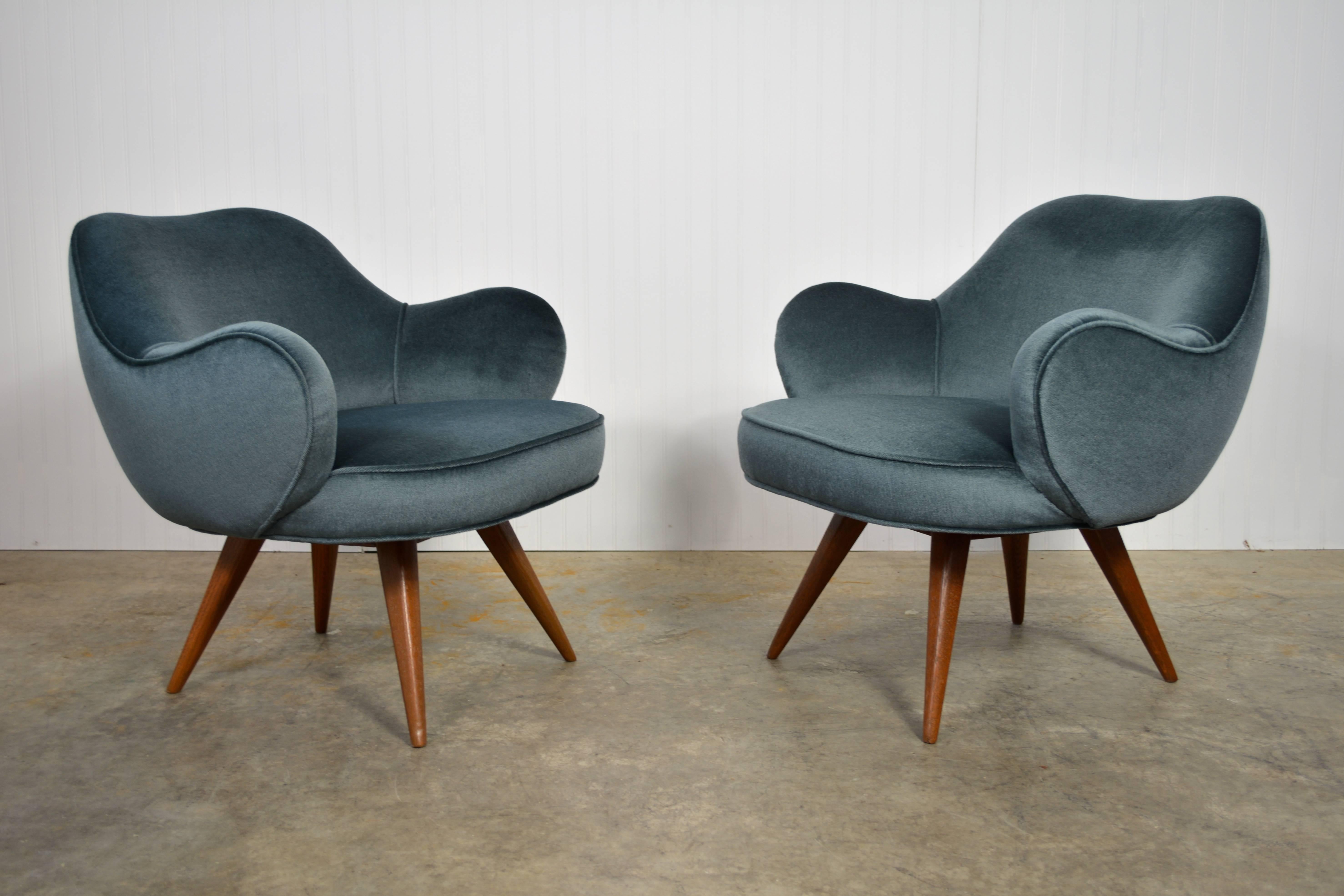 A pair of early and rare lounge chairs by Vladimir Kagan for Kagan-Dreyfuss. Newly refinished walnut legs. Recovered in mohair. 

Reference: The Complete Kagan: A Lifetime of Asvant-Garde Design, Vladimir Kagan. Page 72.
