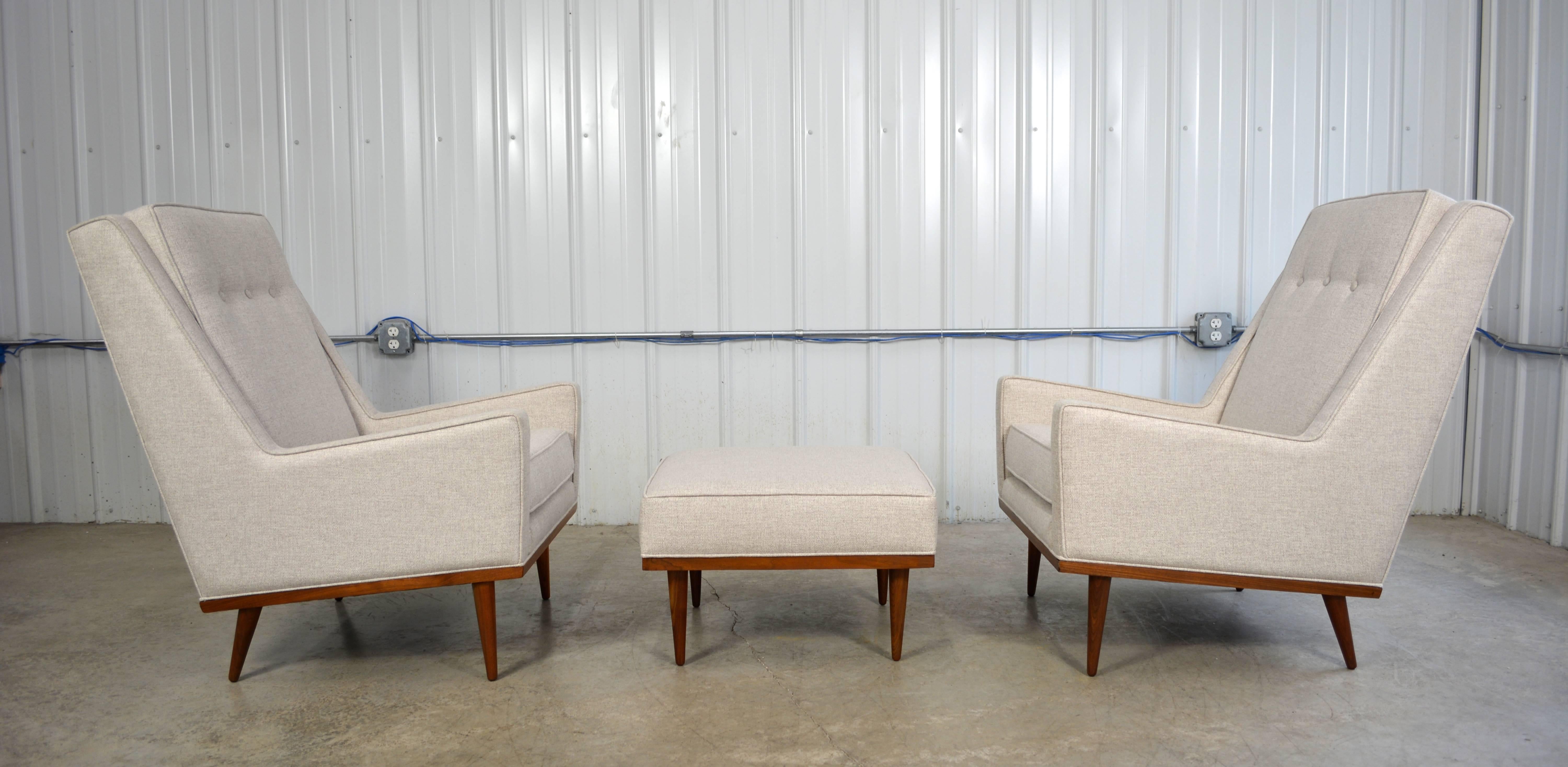 A pair of early lounge chairs and ottoman designed by Milo Baughman for James Inc. This set has been completely restored. Walnut legs and trim along the bottom edge of each piece.