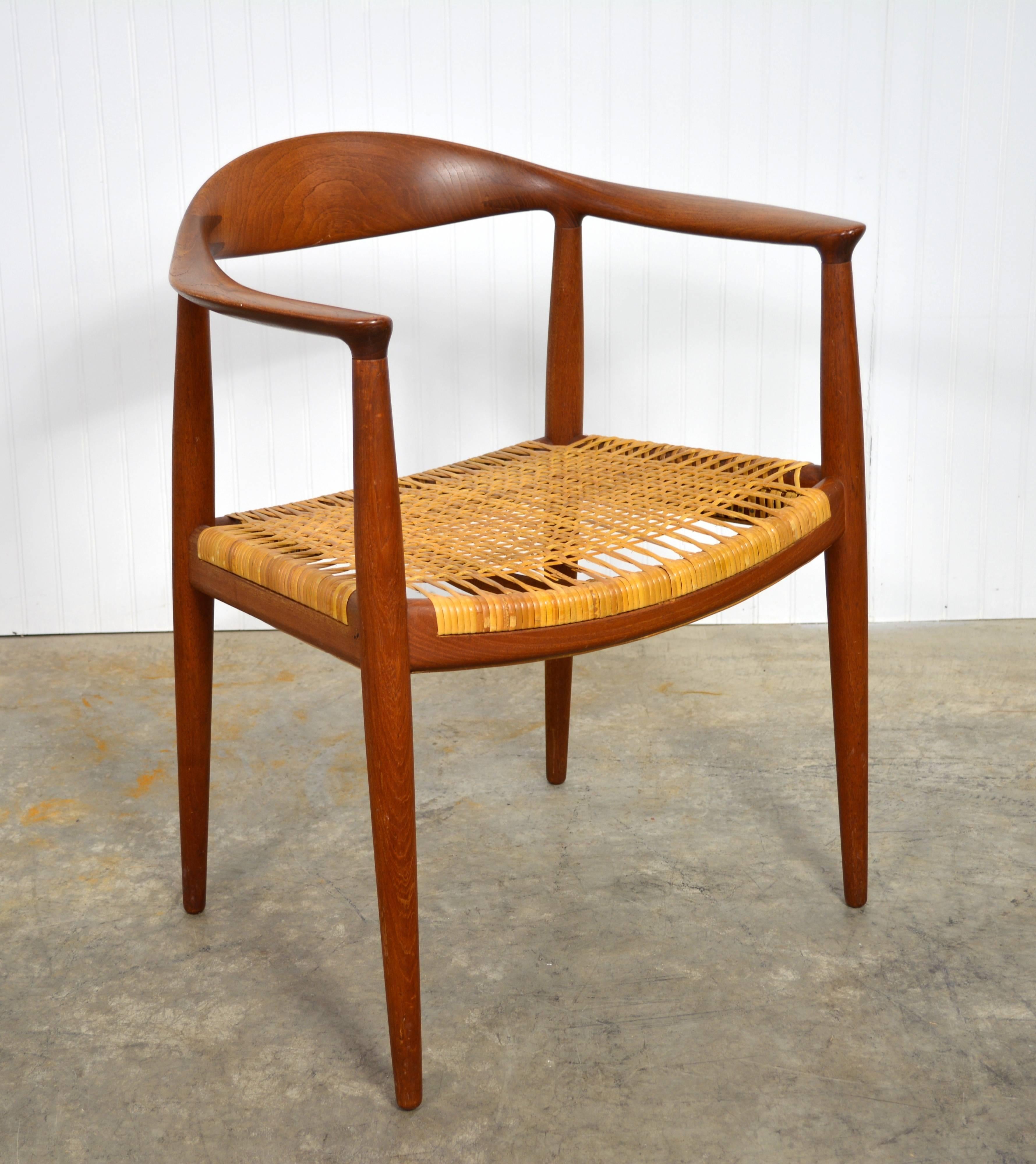 A set of four "Round" chairs designed by Hans Wegner. Solid teak frames and caned seats. All four a stamped with the maker's mark. Very minor wear to caning.