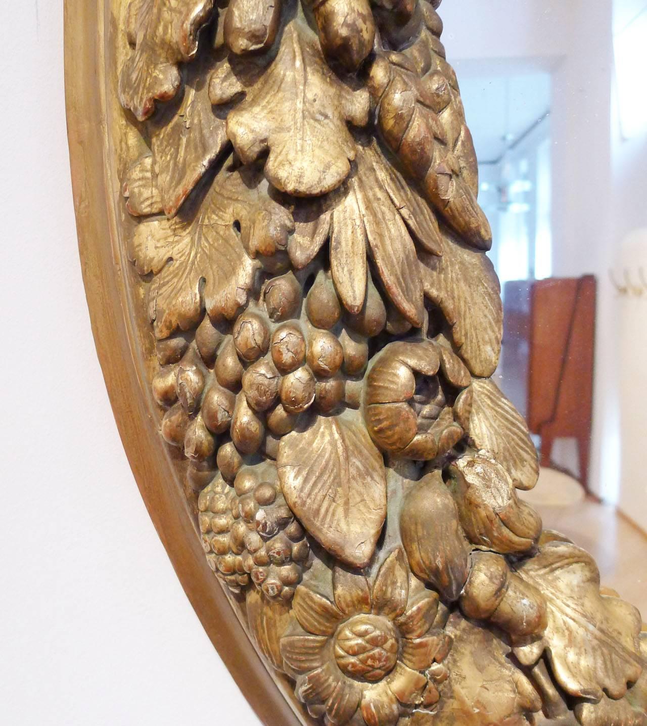 Beautifully and exquisite carved gilded Art Déco Mirror, decorated with flowers, fruits and leafs.
 