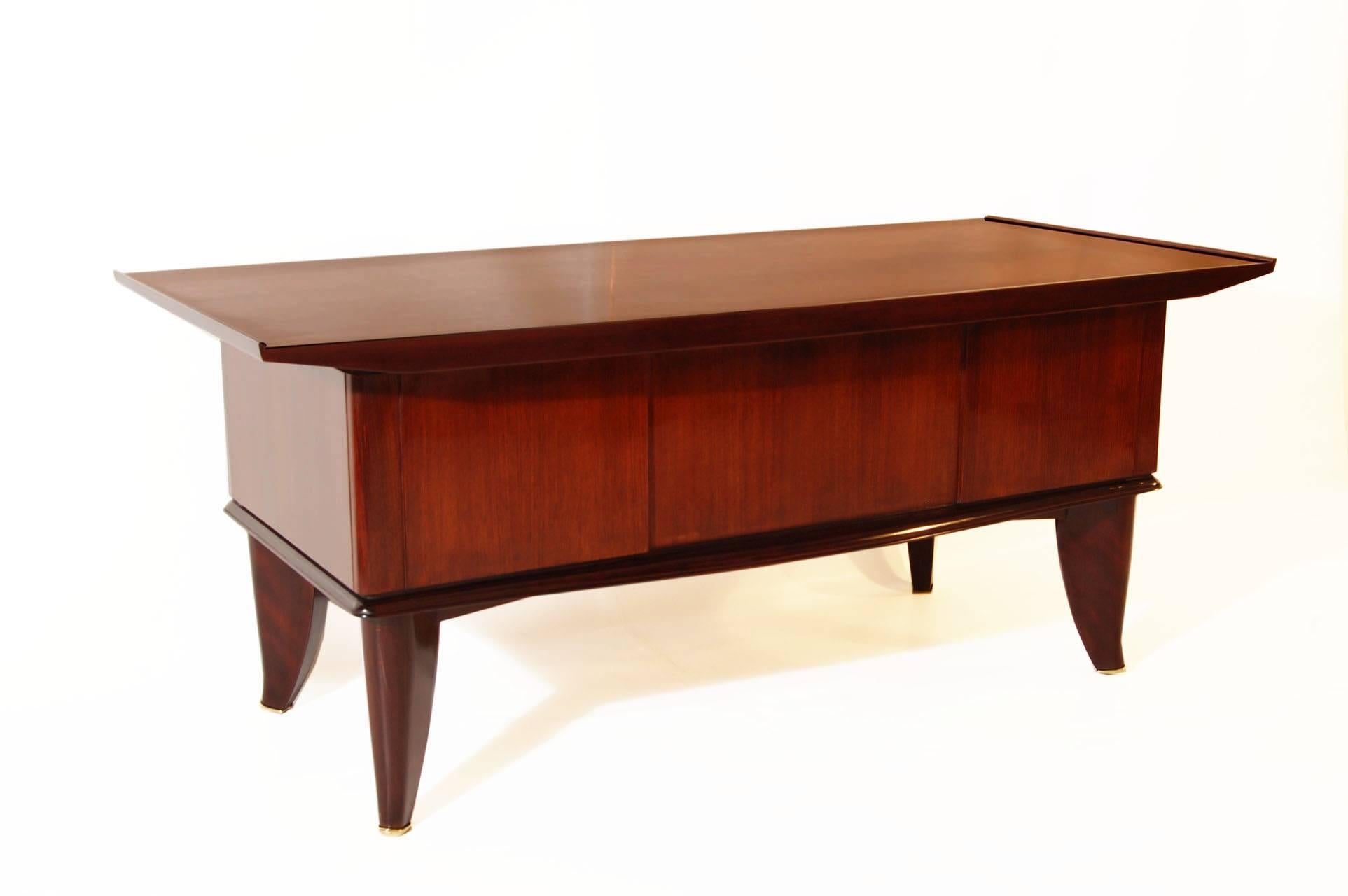 Beautiful rosewood desk with brass sabots and pulls, which was designed by Sanyas et Popot, Paris.
Very typical and elegant Art Deco design.