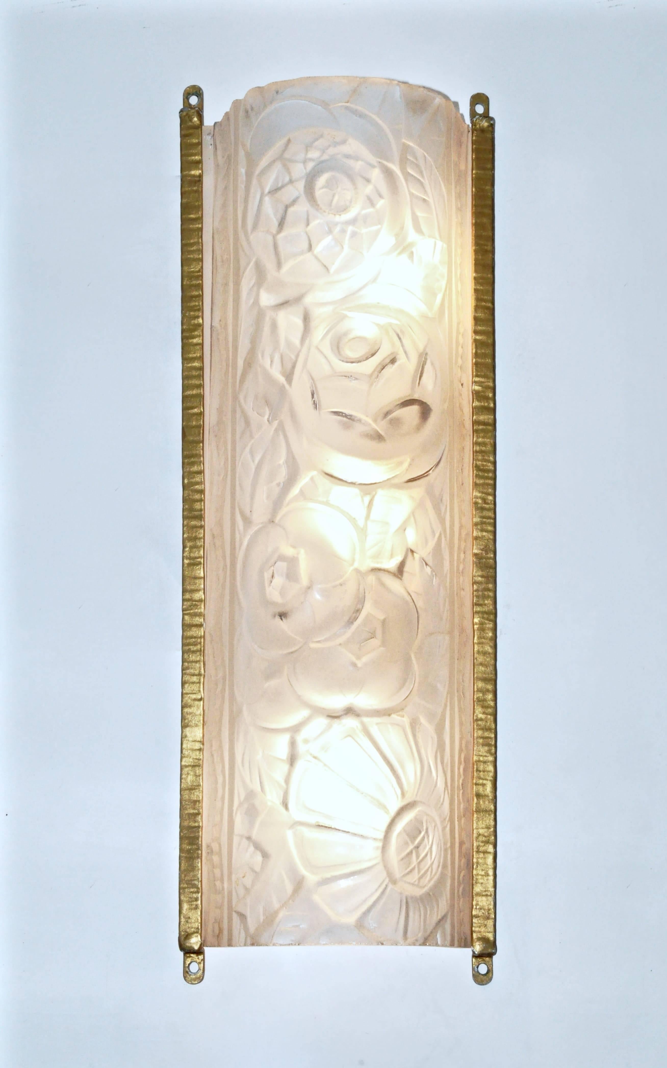 Elegant sconces by Degue. Clear and frosted glass shades molded with a floral motif and mounted in a modern brushed nickel frame.